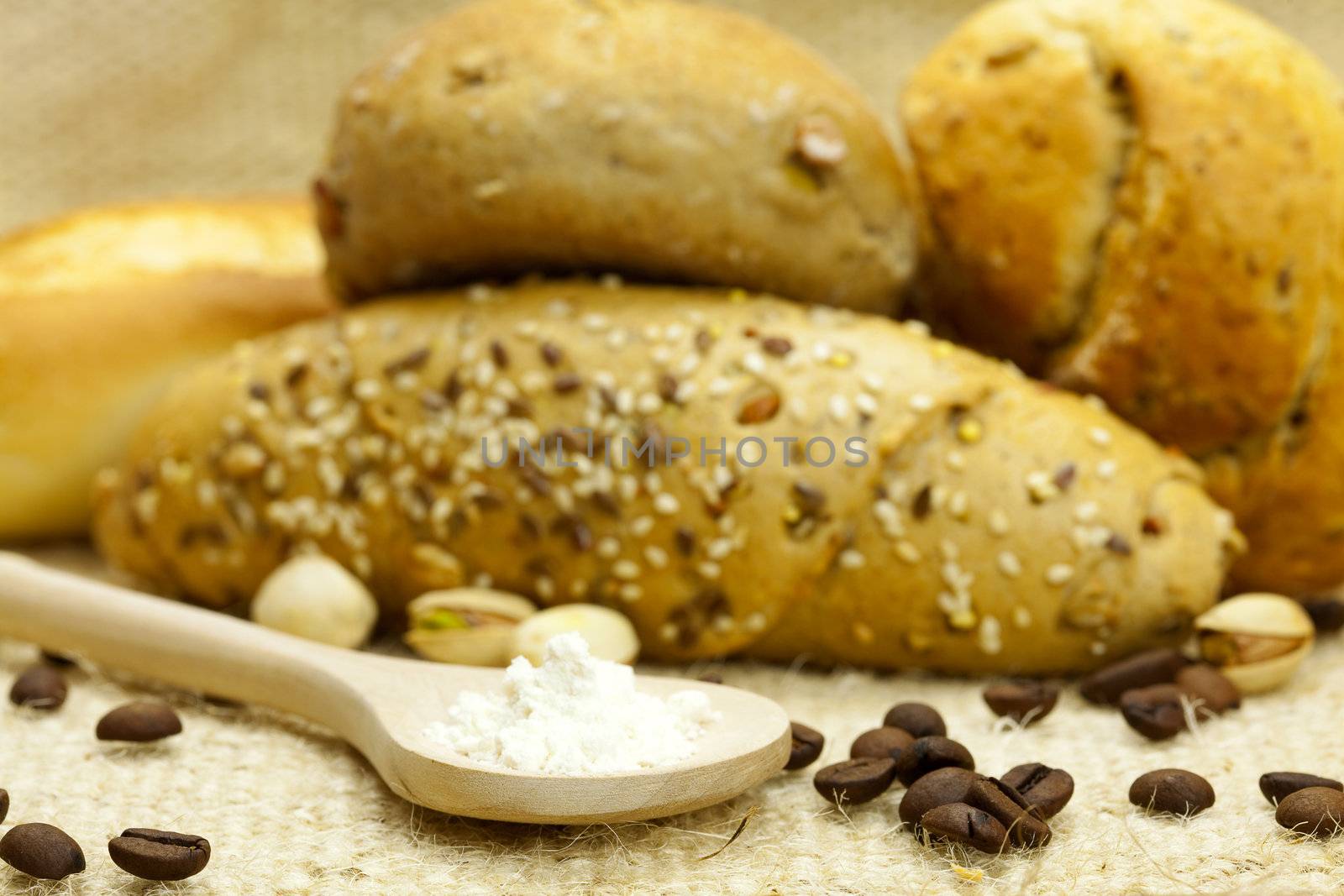 bread and coffee ,flour in a spoon on a  linen fabrics by jannyjus