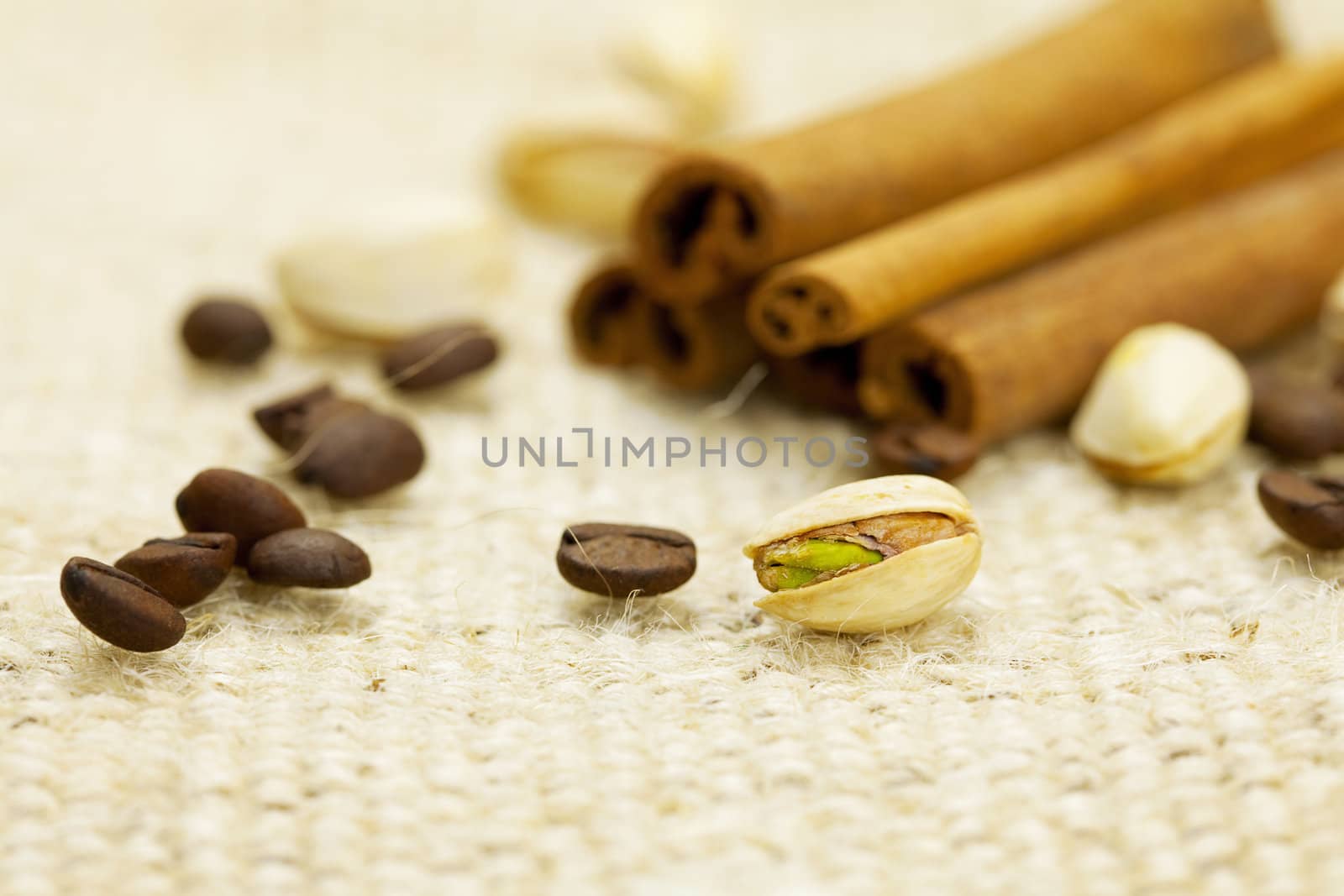 cinnamon, pistachios and coffee beans on the canvas fabric