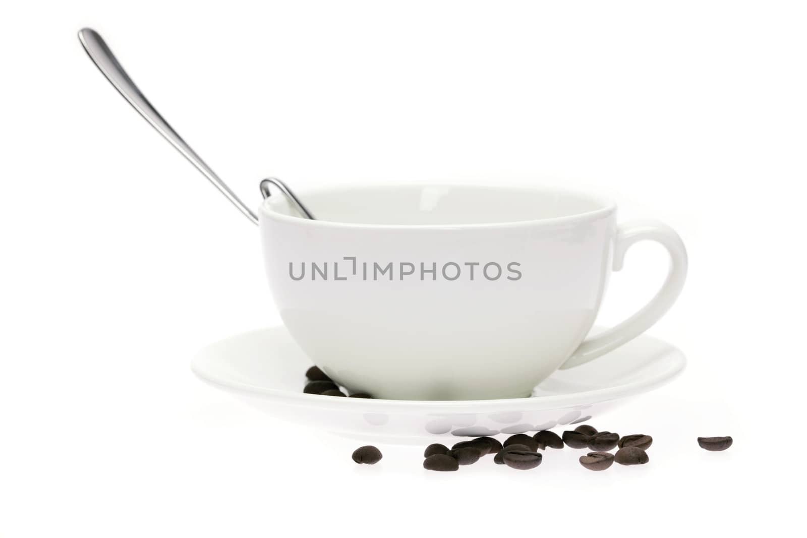 cup and saucer and coffee beans isolated on white by jannyjus