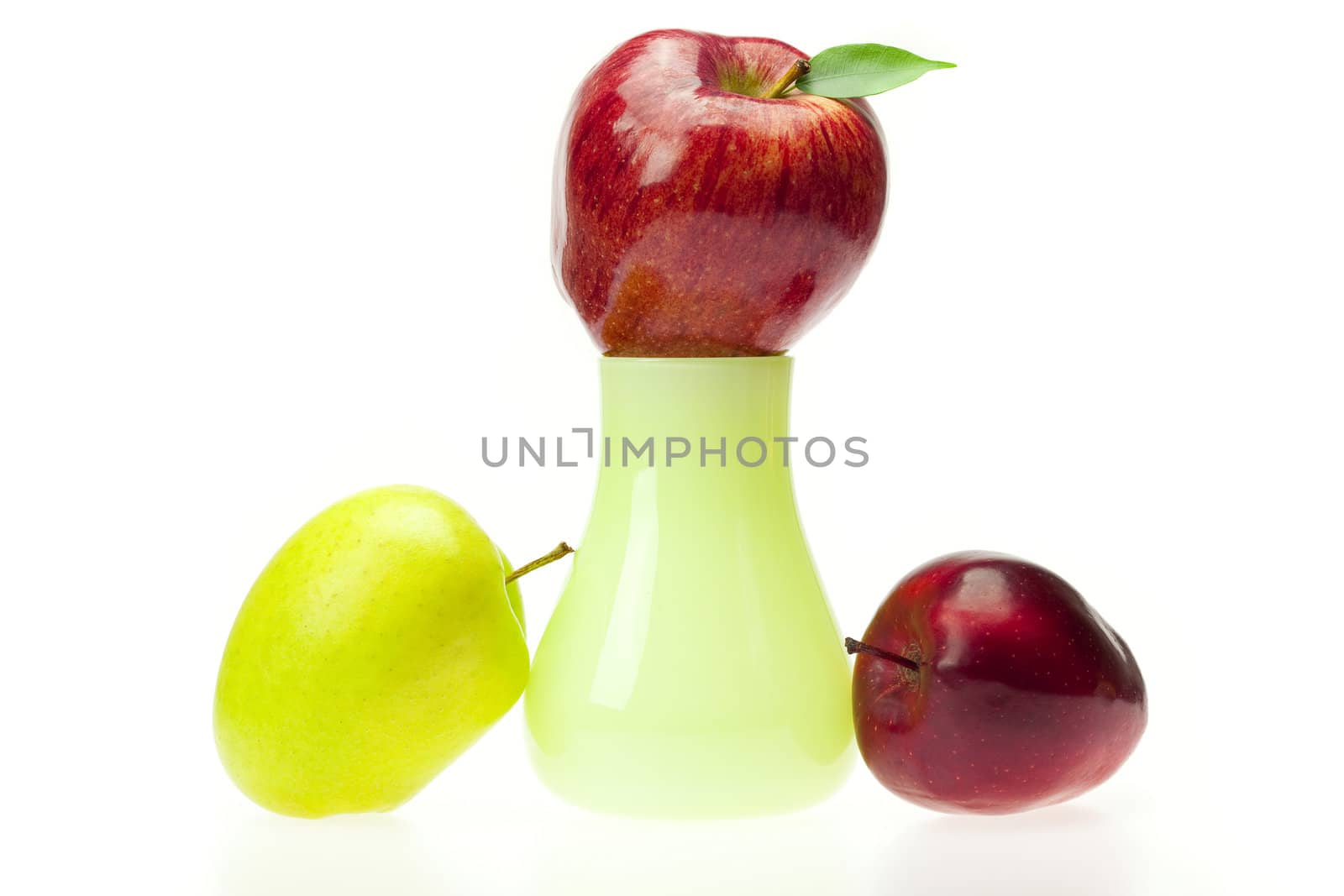 apples with green leaves  in the vase   isolated on white by jannyjus