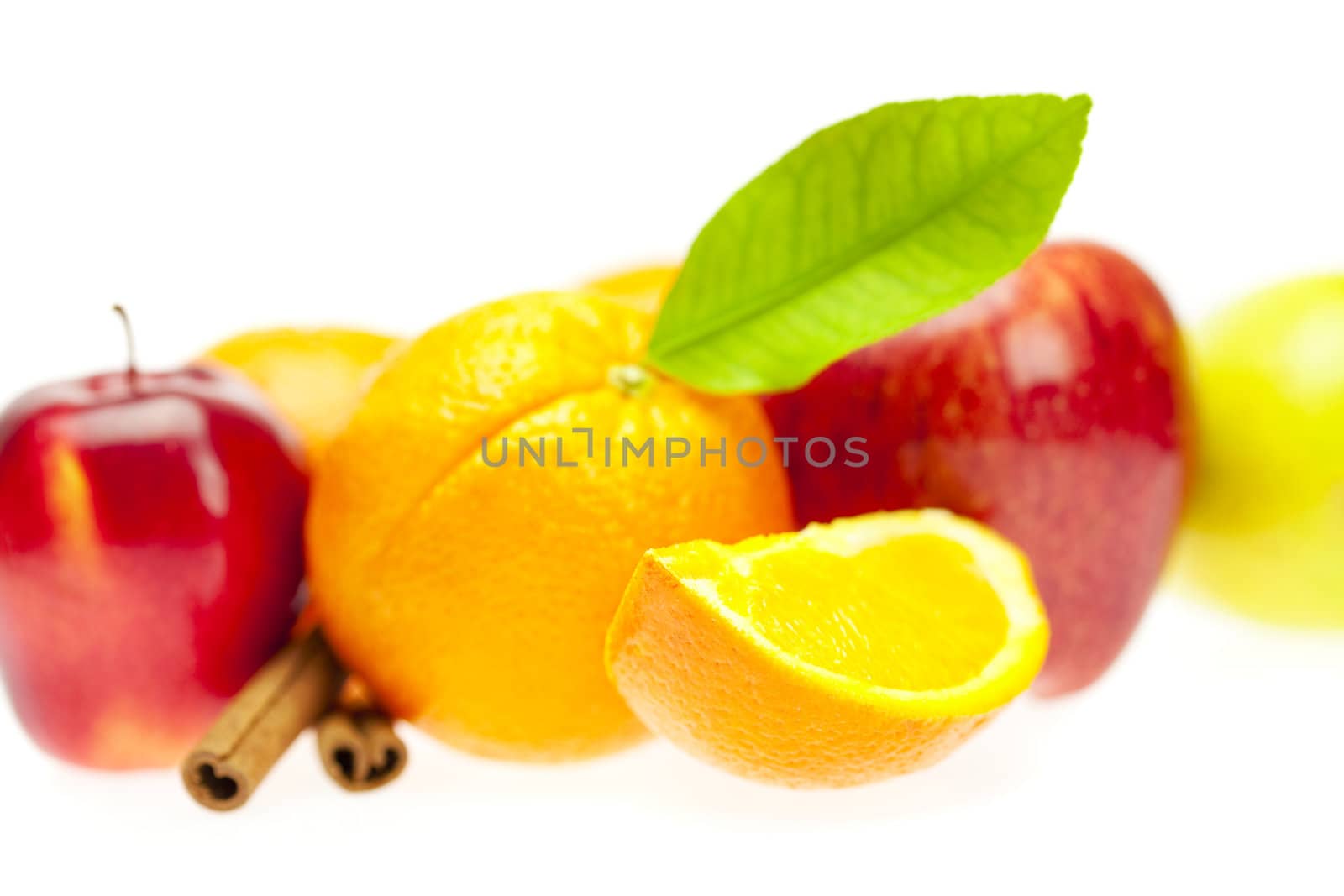 oranges, cinnamon sticks and apples  isolated on white