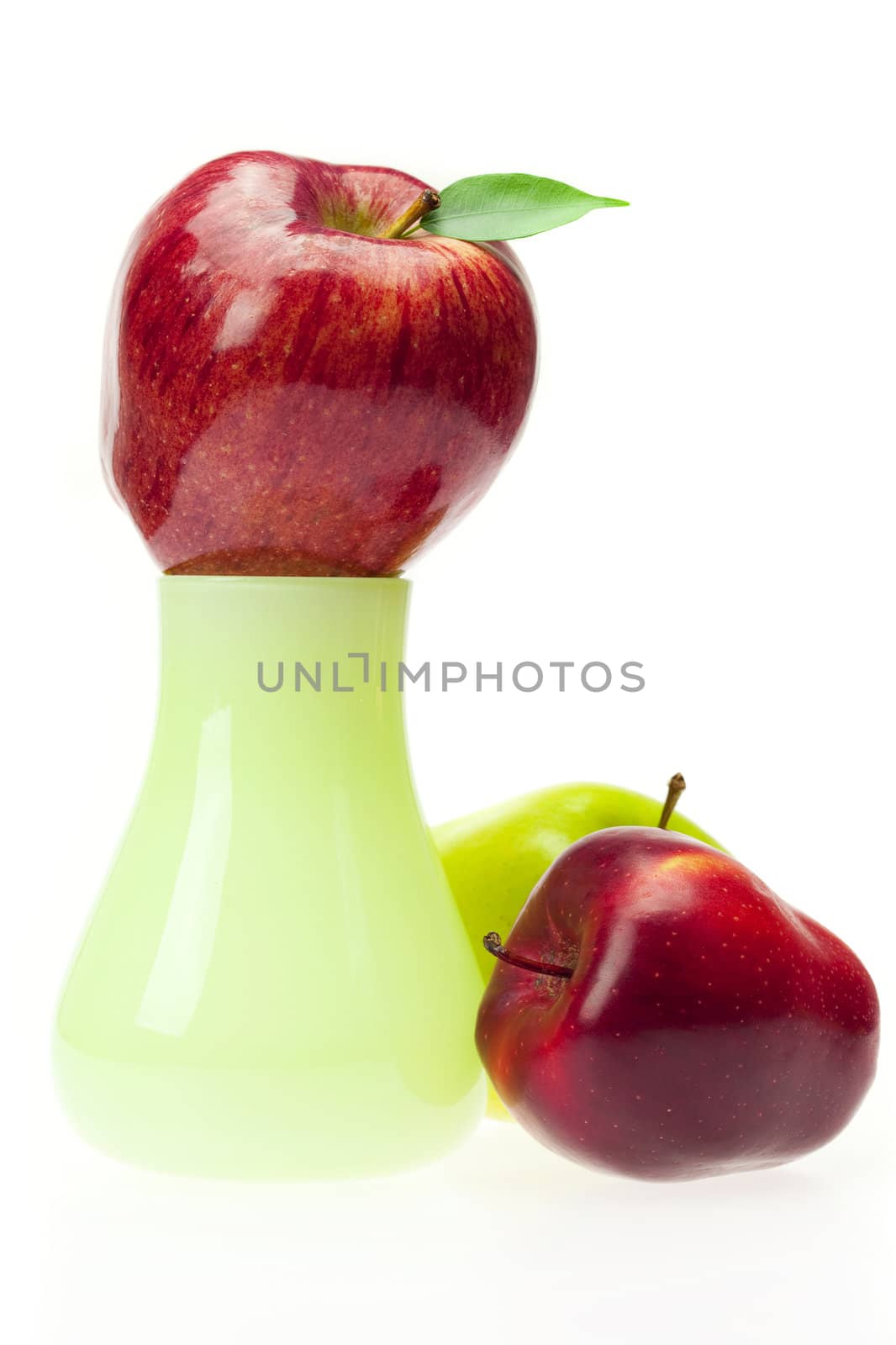 apples with green leaves  in the vase   isolated on white by jannyjus