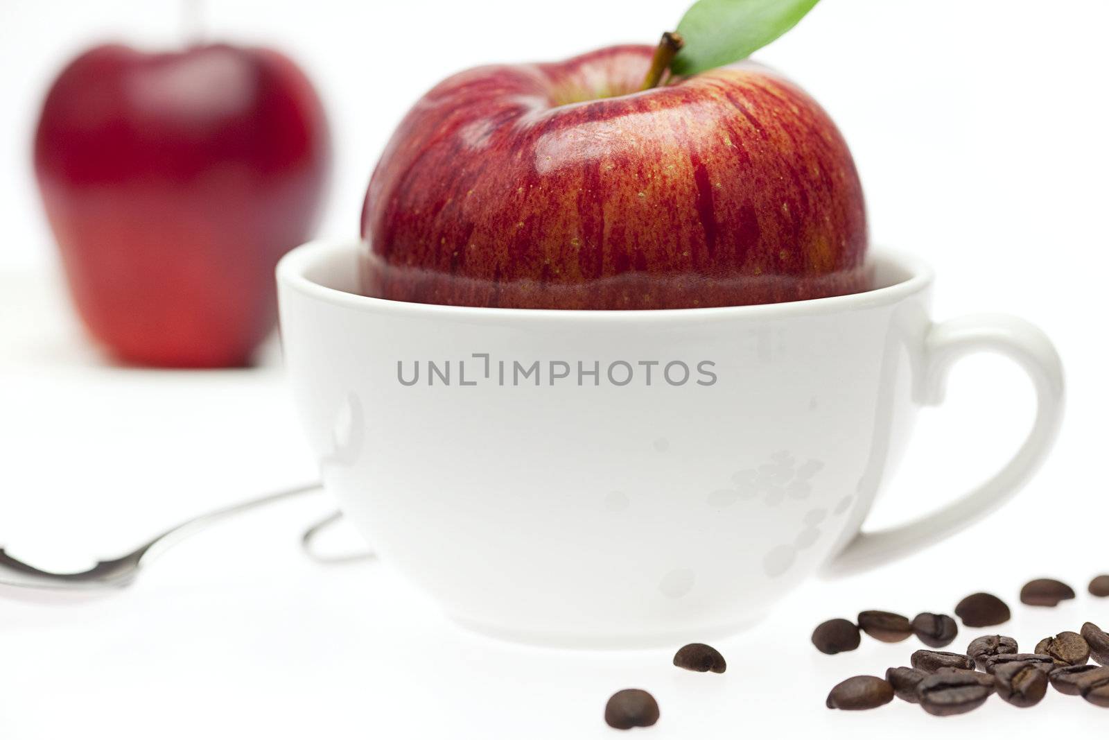 apples in a bowl, spoon and coffee beans isolated on white