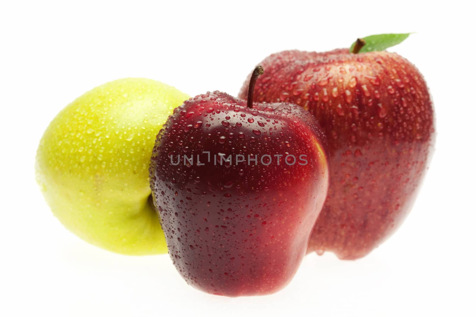 apples with green leaves isolated on white