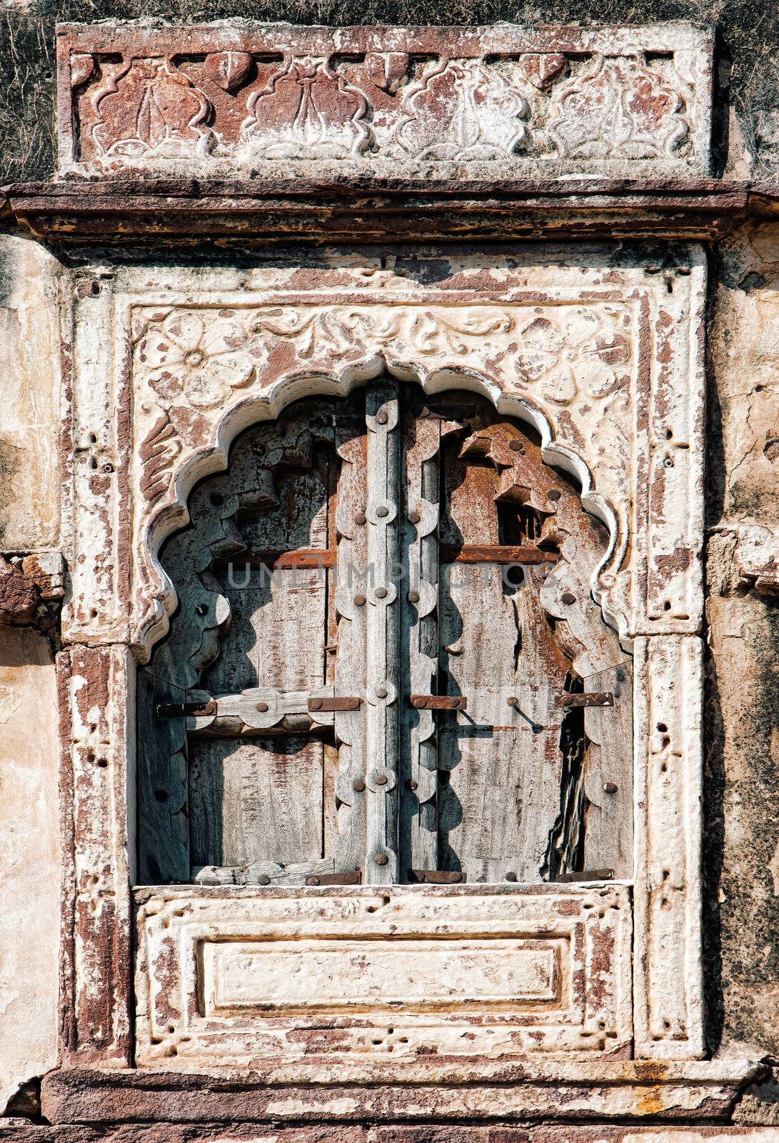 Old window and wooden shutters with stone-carved architraves, background. India, Asia