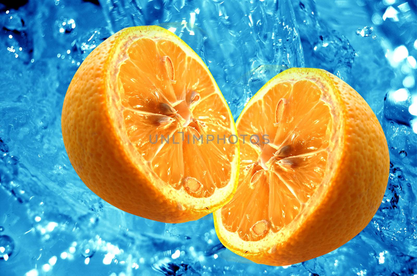 Fresh halves of orange on water background