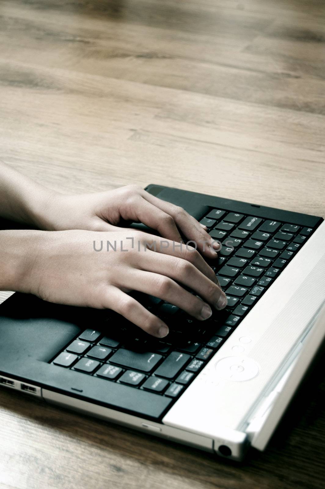 Typing on laptop by photocreo