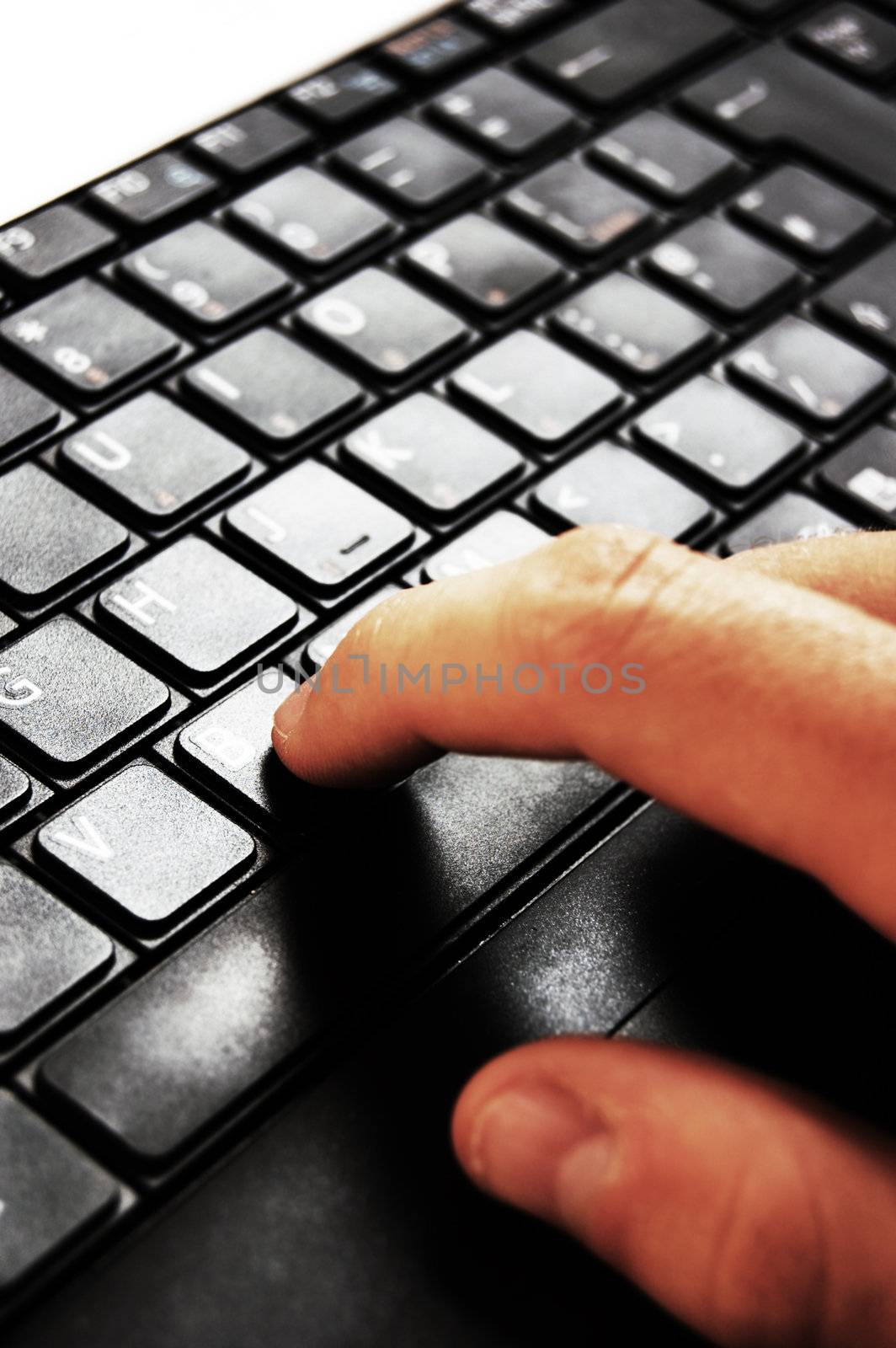 Hands typing on a laptop in home