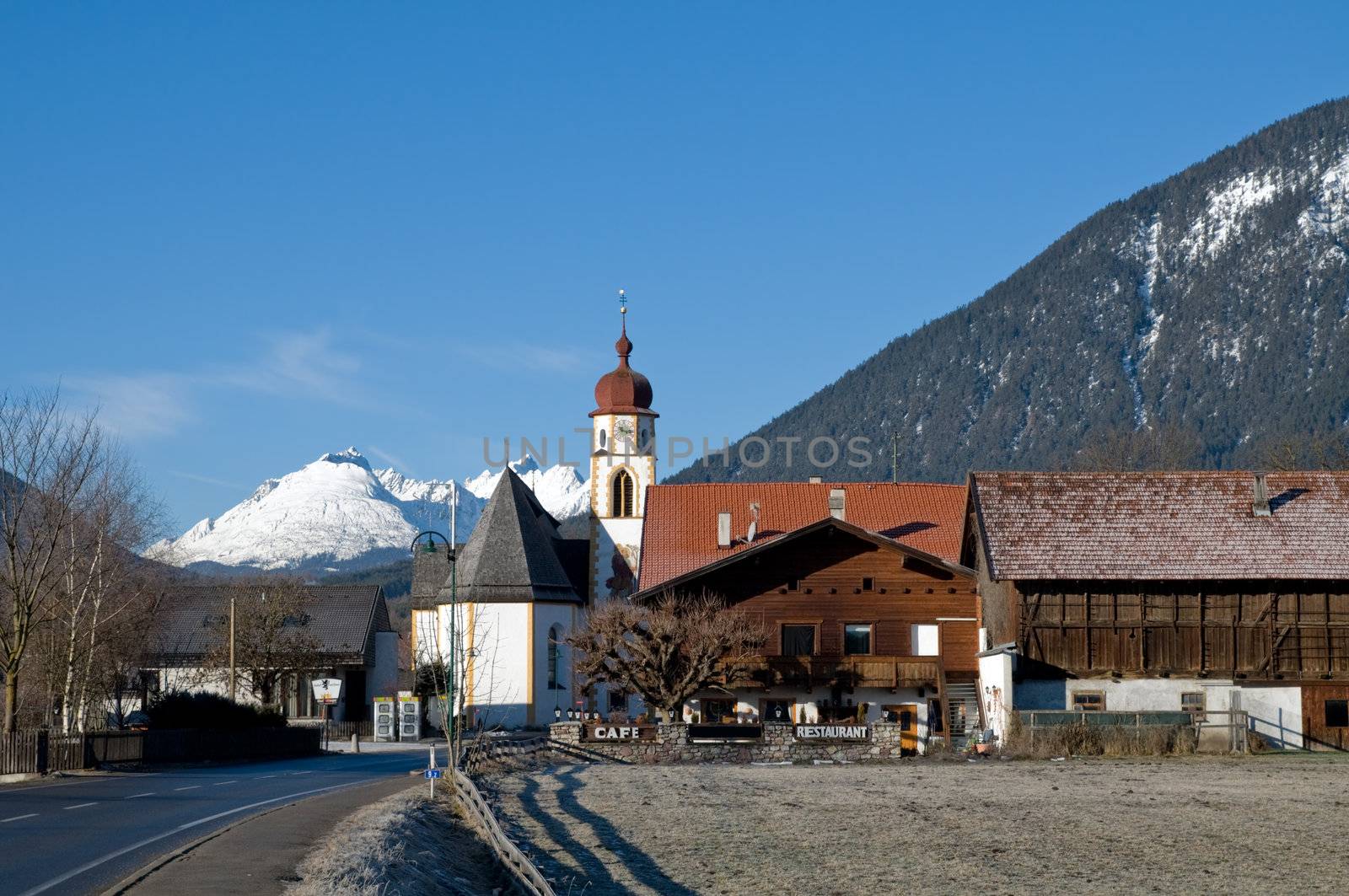Mountain village in the Alps with church in the foreground