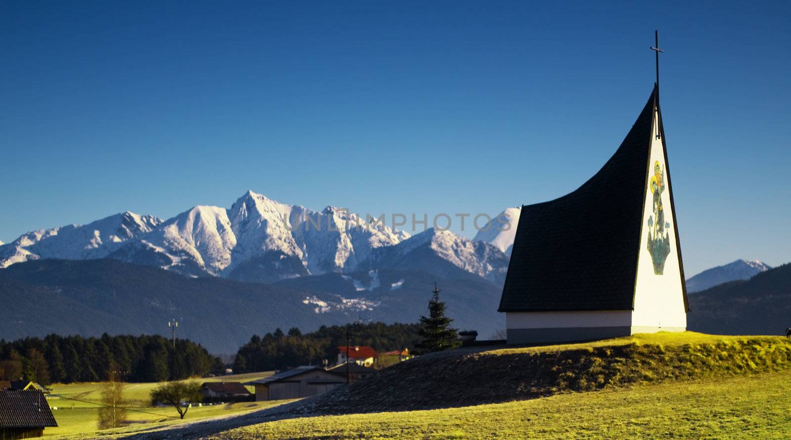 Spring Alpine landscape with blue sky and sun