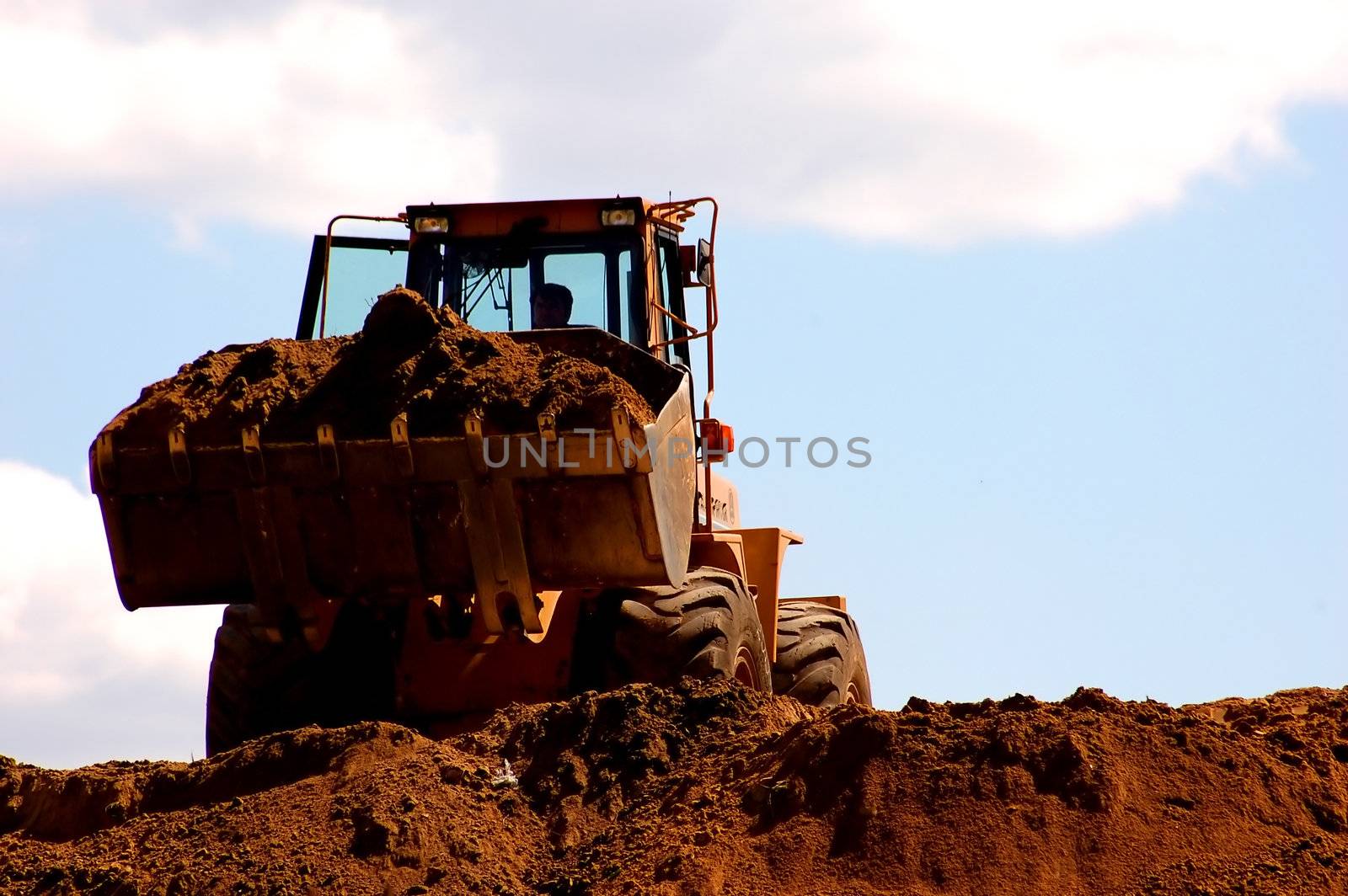 Excavator working by photocreo