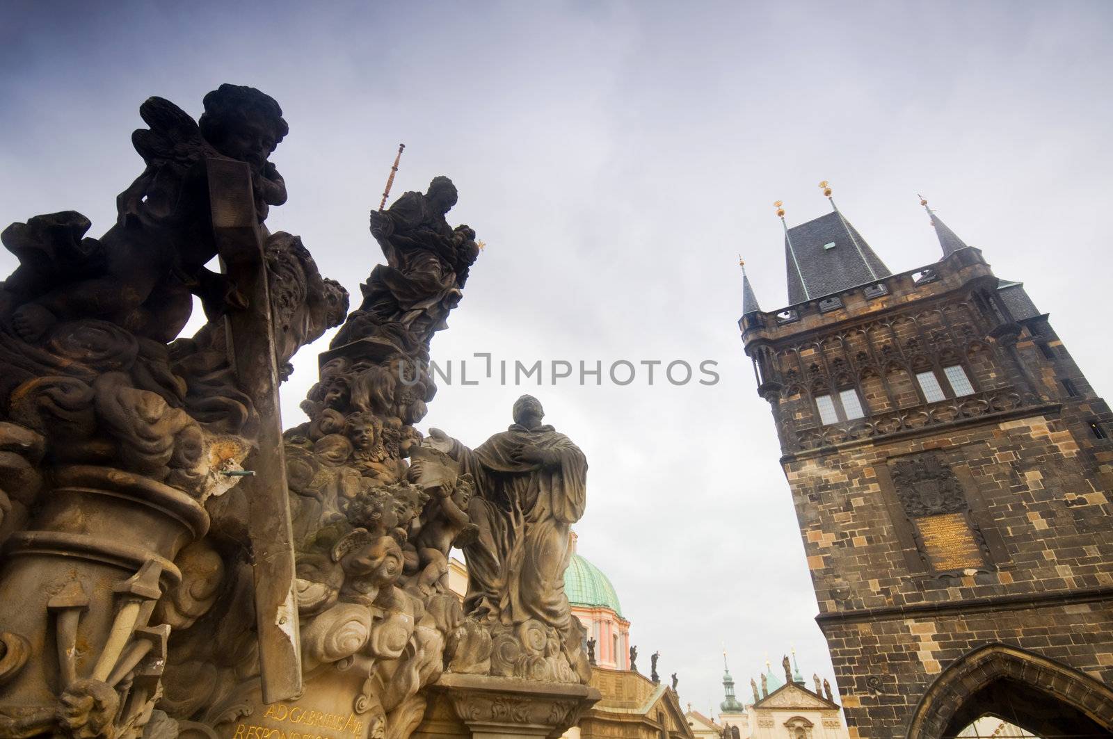 Statues on Charles Bridge and Bridge Tower in Prague.