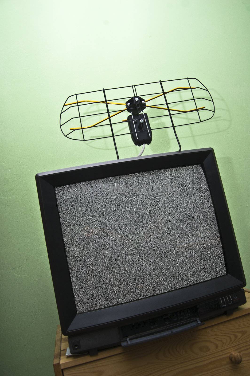 Aerial and old TV set with noisy picture. 