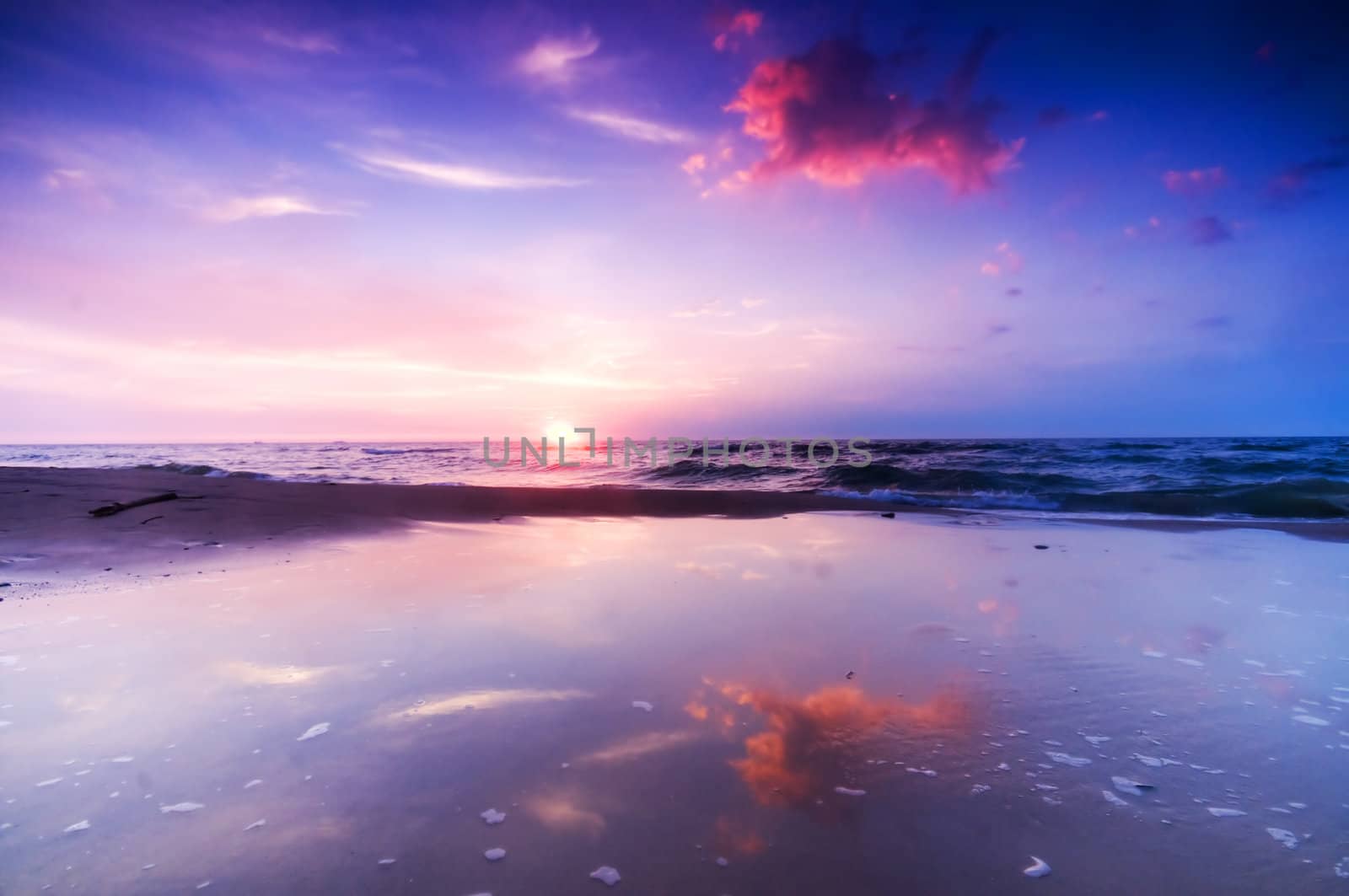 Beautiful sea sunrise. Colorful sky and water reflection