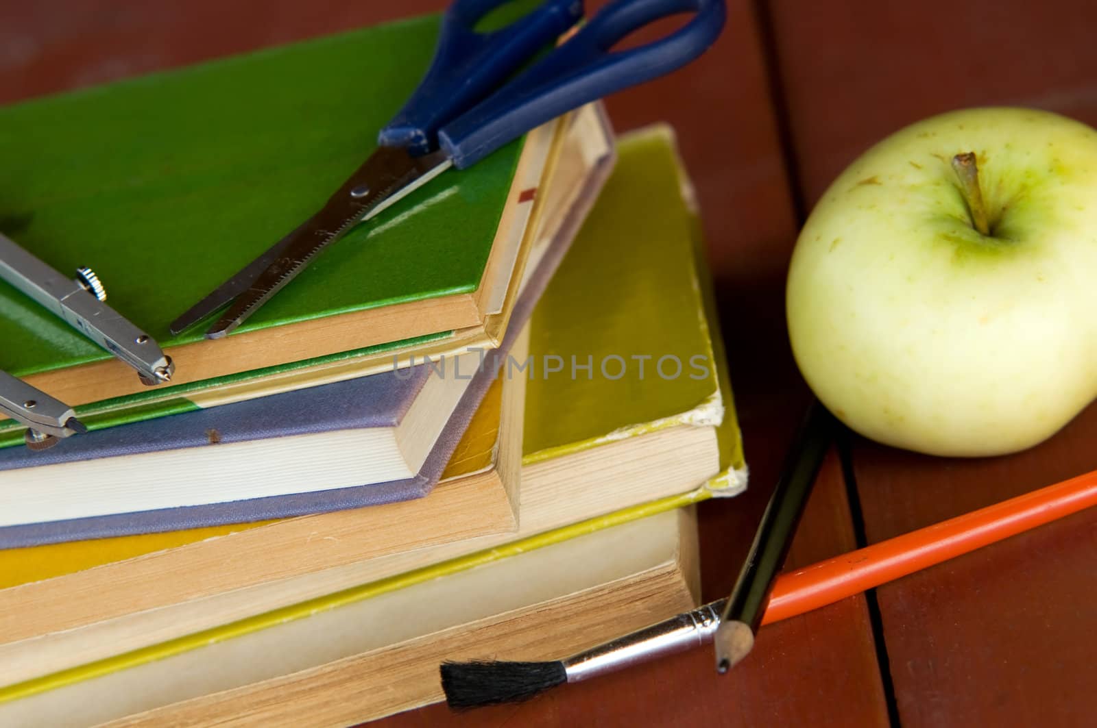 Pile of books, apple and school equipment. Education concept, back to school.