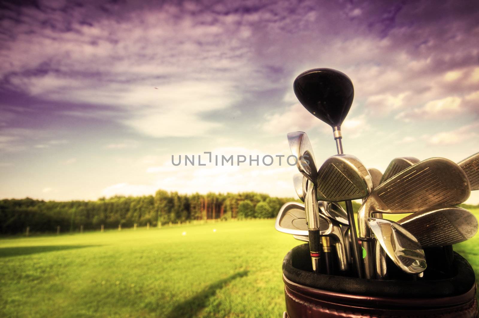 Professional golf gear on the golf field at sunset.