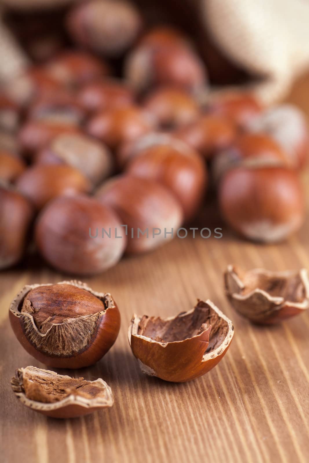 Closeup view of hazelnuts on a wooden table