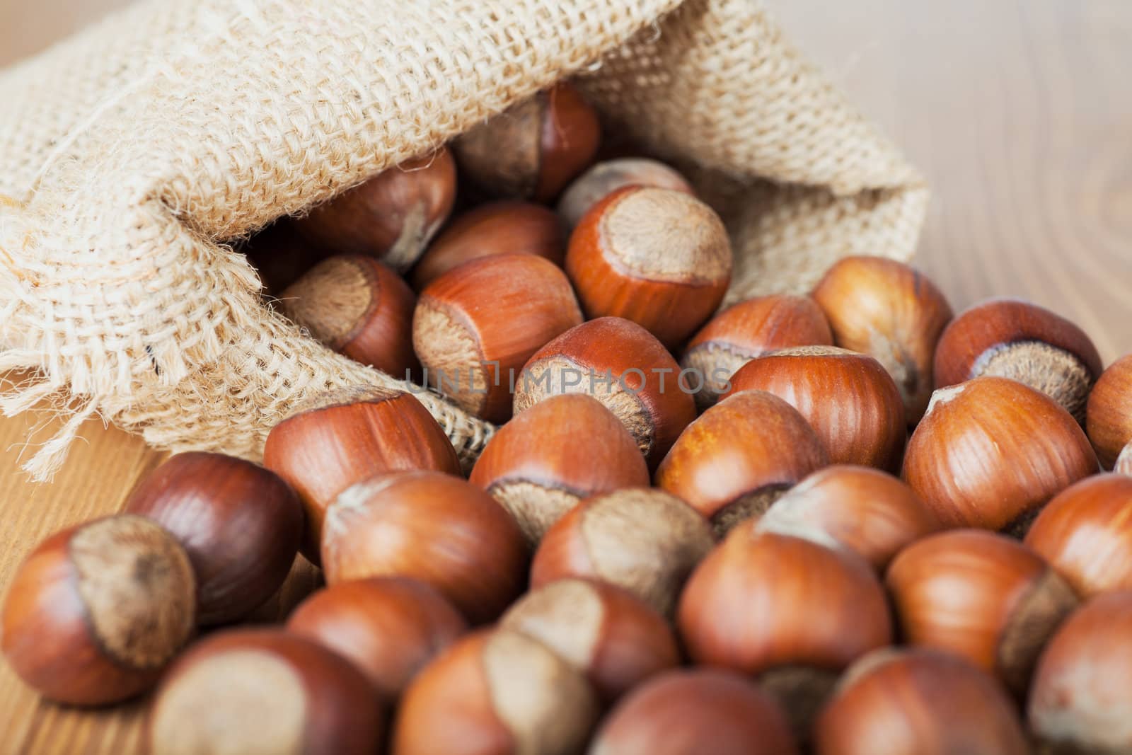 Closeup view of hazelnuts on a wooden table
