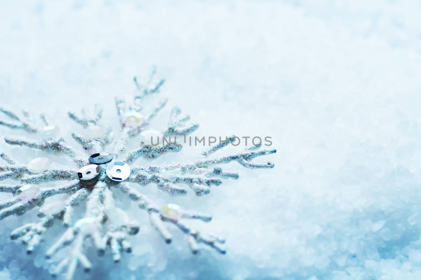 Frosty snowlake in snow Christmas decoration background