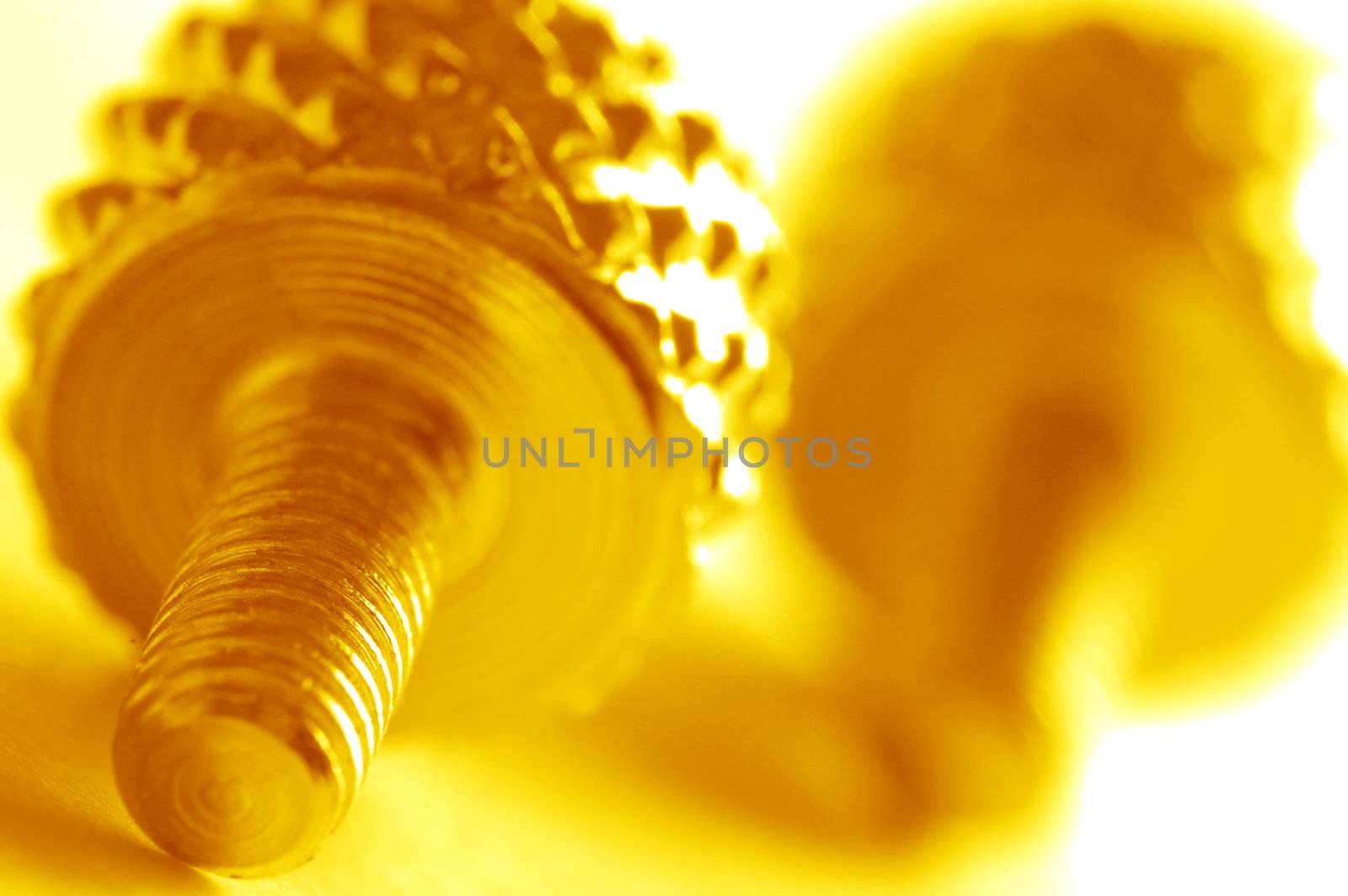 Yellow screw close-up. Conceptual image 