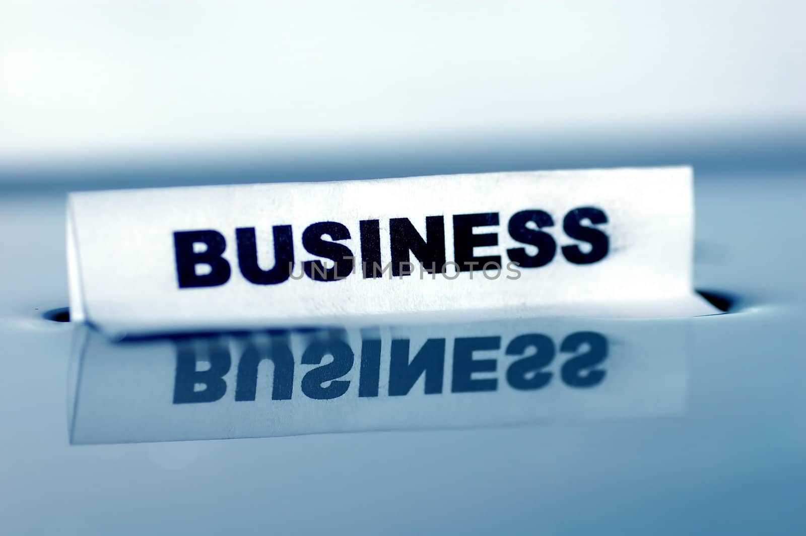 Card floating on water surface with printed word: BUSINESS