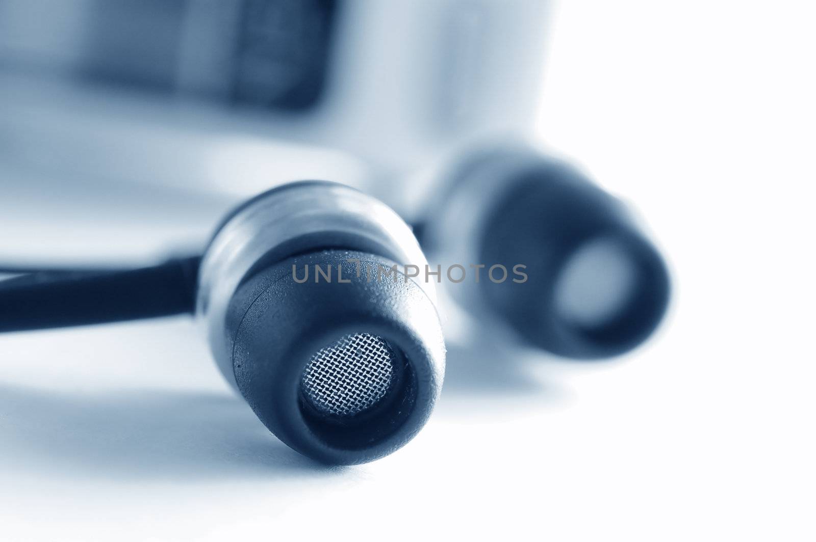 Modern headphones and music player in the background
