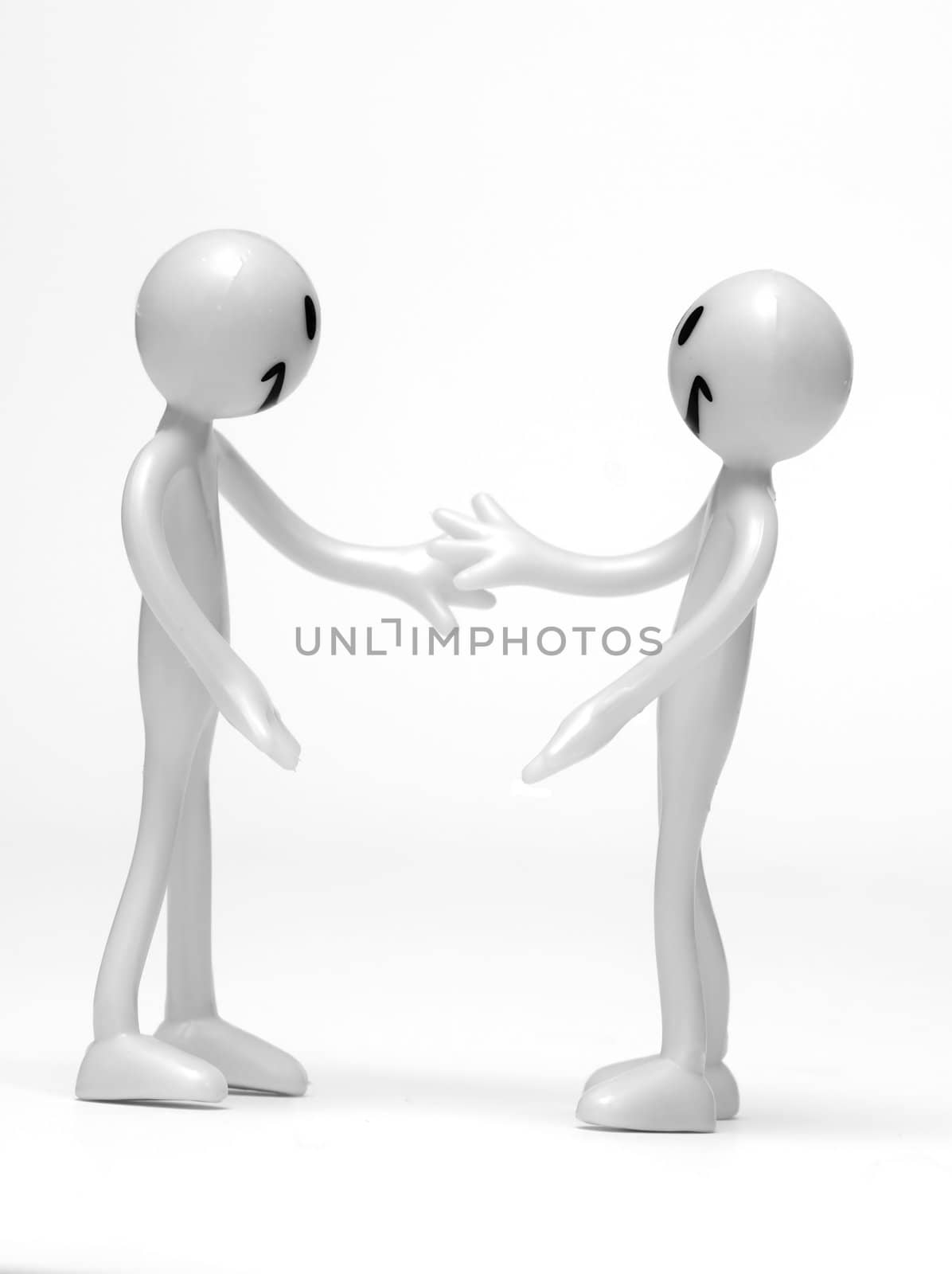 Business handshake by two figures. Conceptual