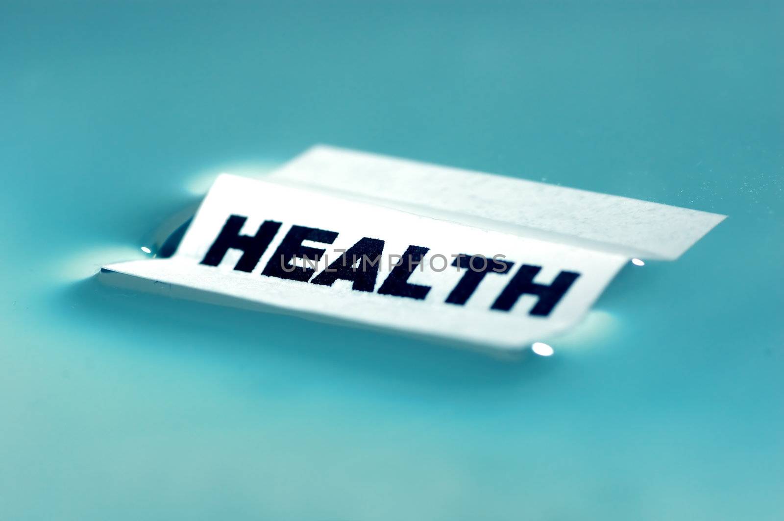 Card floating on water surface with printed word: HEALTH
