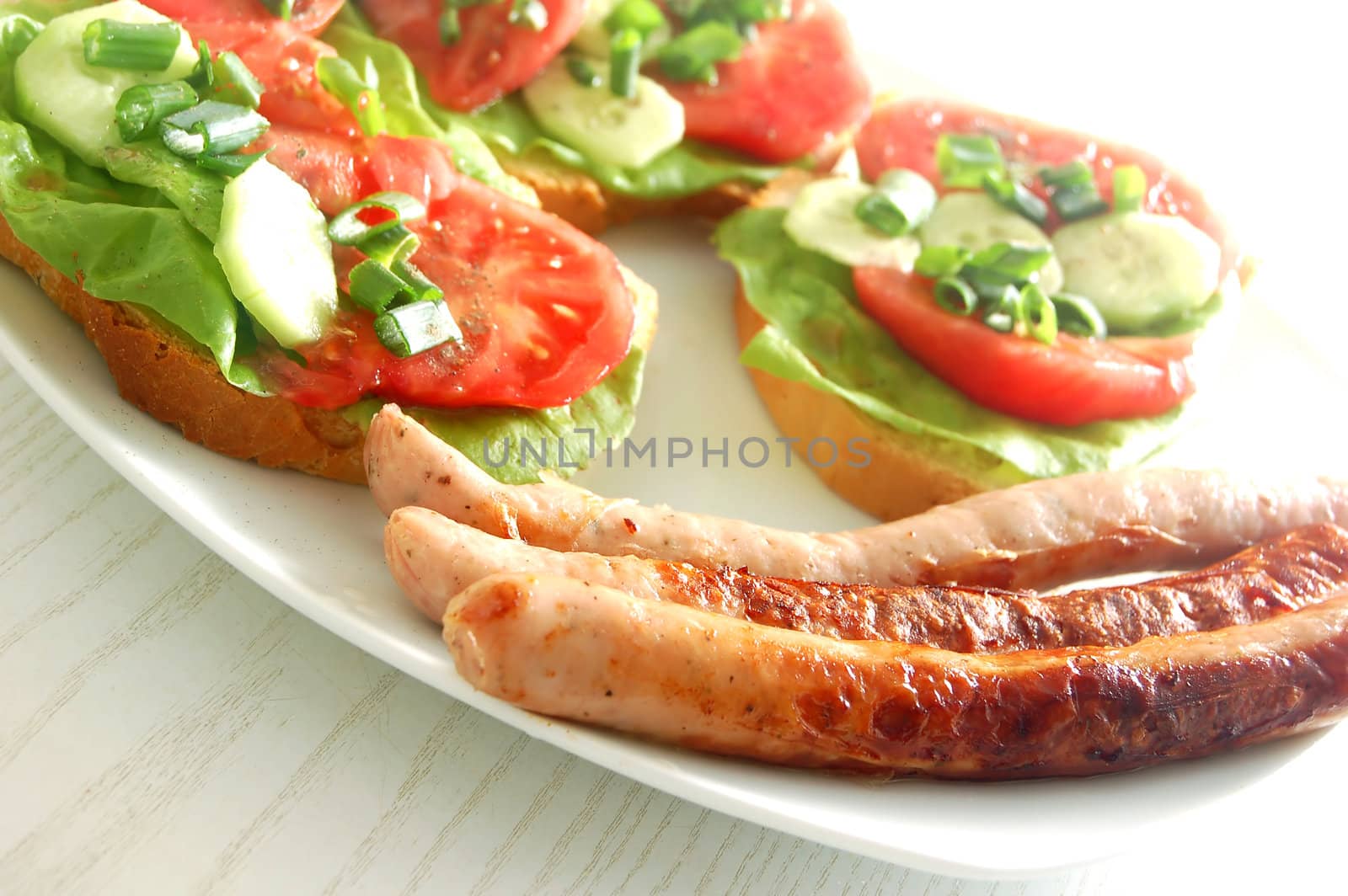 Plate with sandwiches and sausages