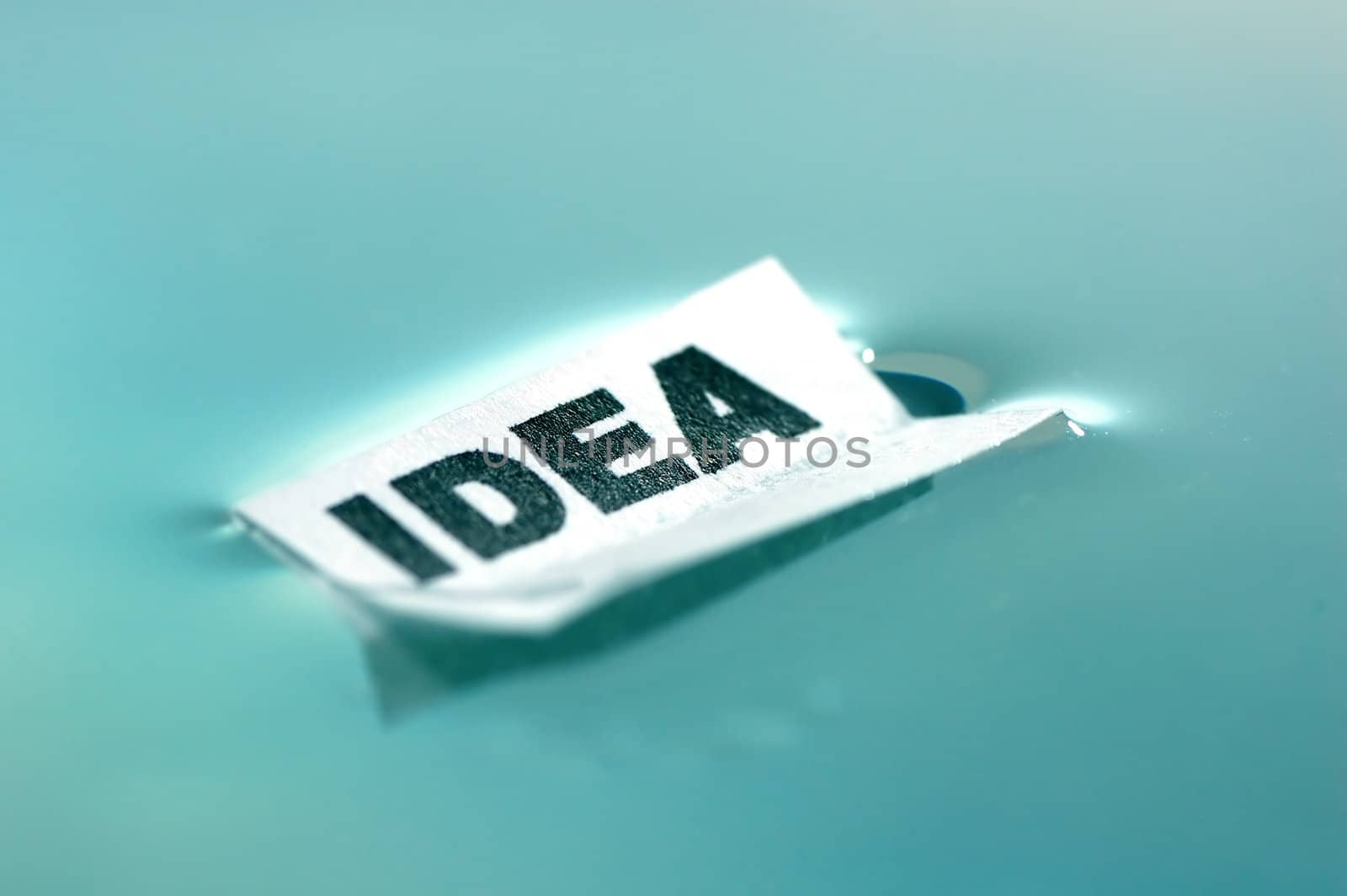Card floating on water surface with printed word: IDEA