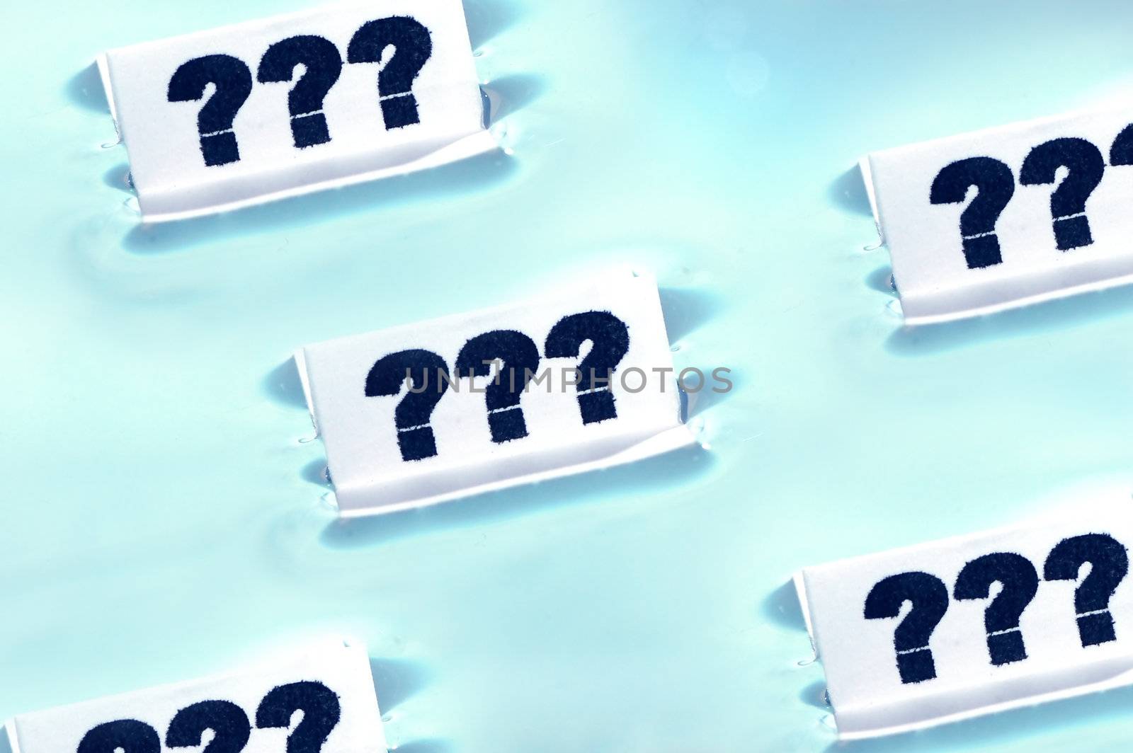 Cards floating on water surface with printed: ???