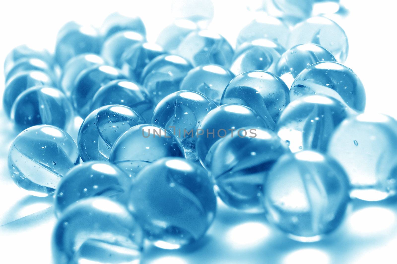 A background of colourful glass marbles. Blue version 