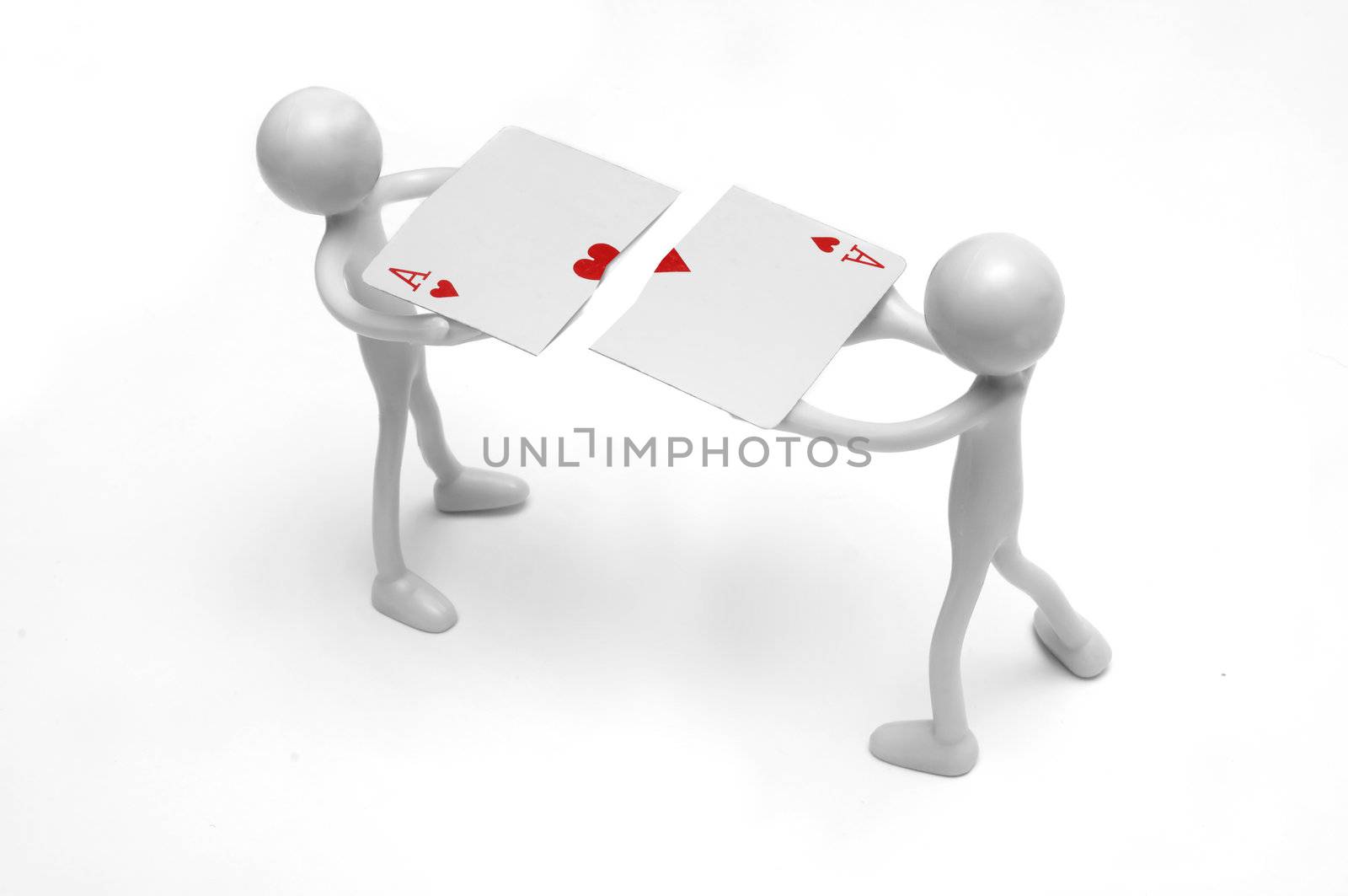 Two human figures tear a card. Conceptual