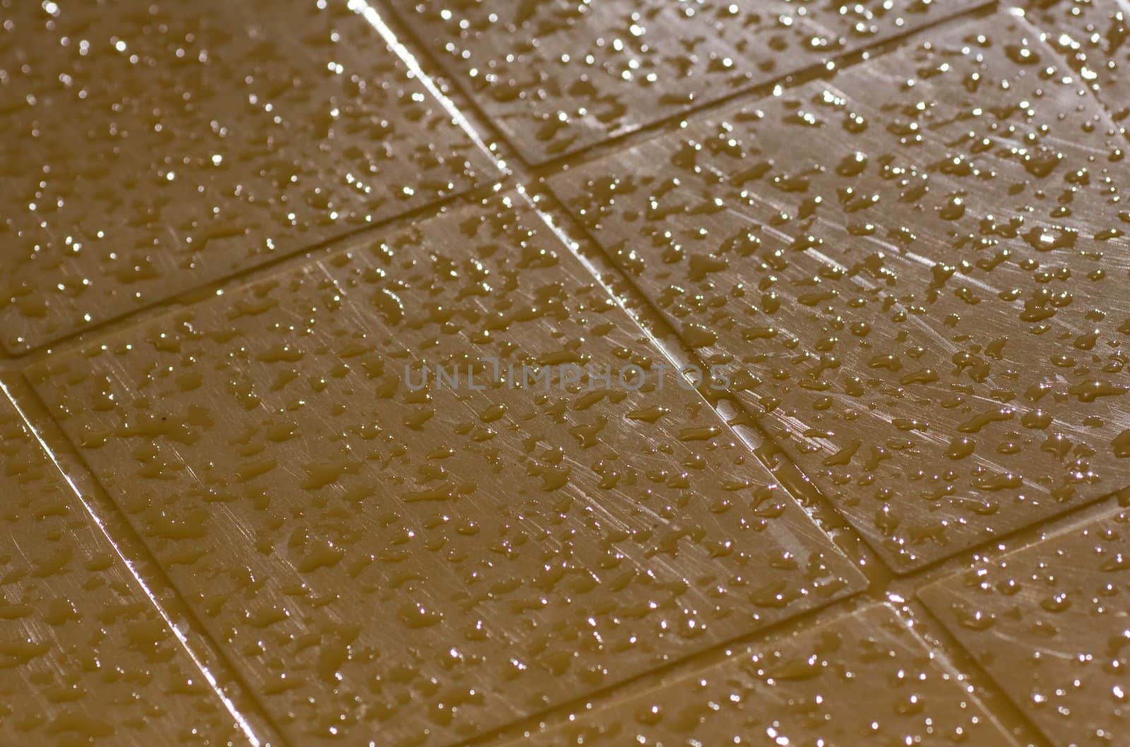 Water drops on yellow surface