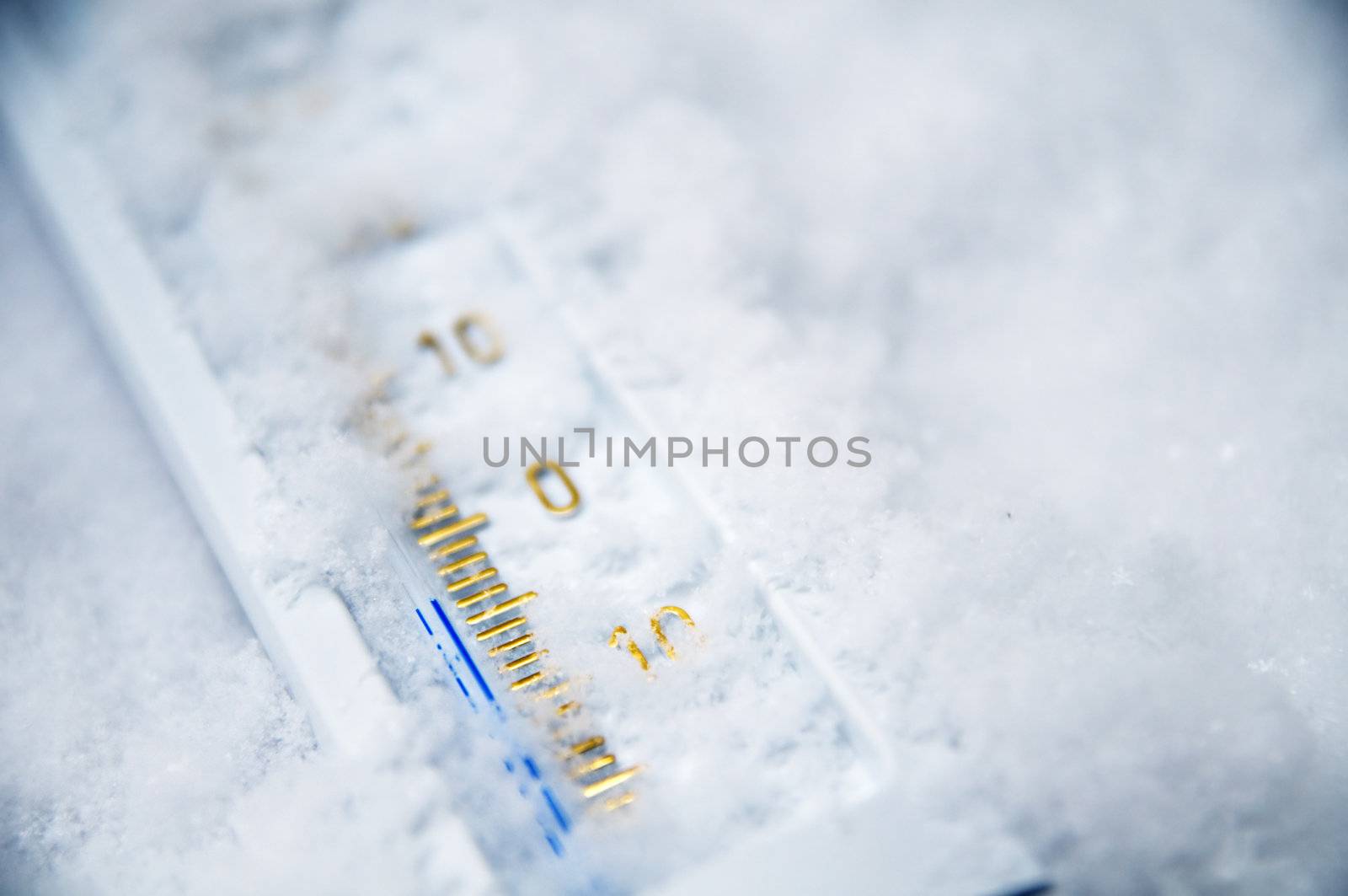 Below zero. Thermometer in snow indicating minus temperature. Cold winter concept.