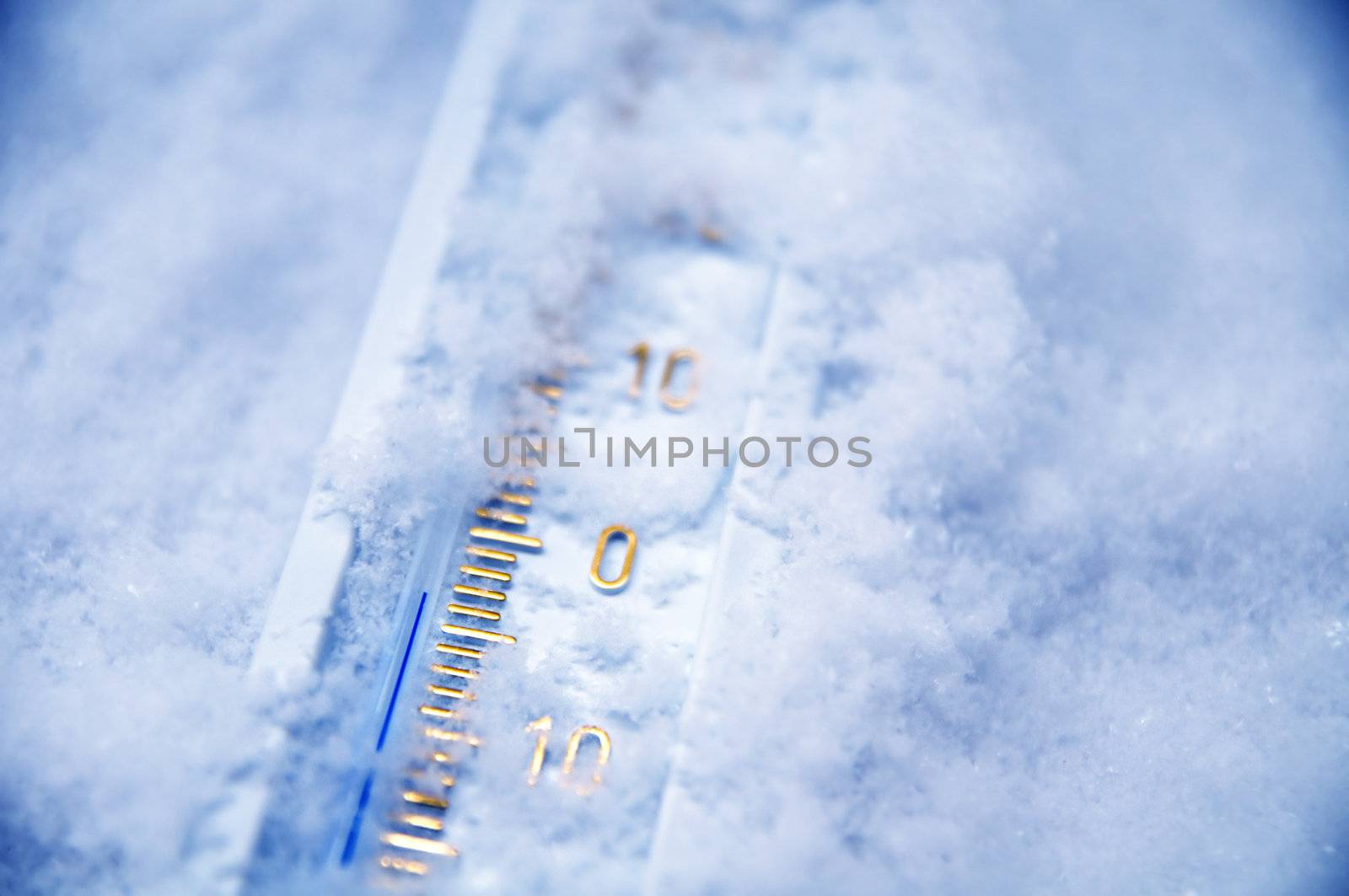 Below zero. Thermometer in snow indicating minus temperature. Cold winter concept.