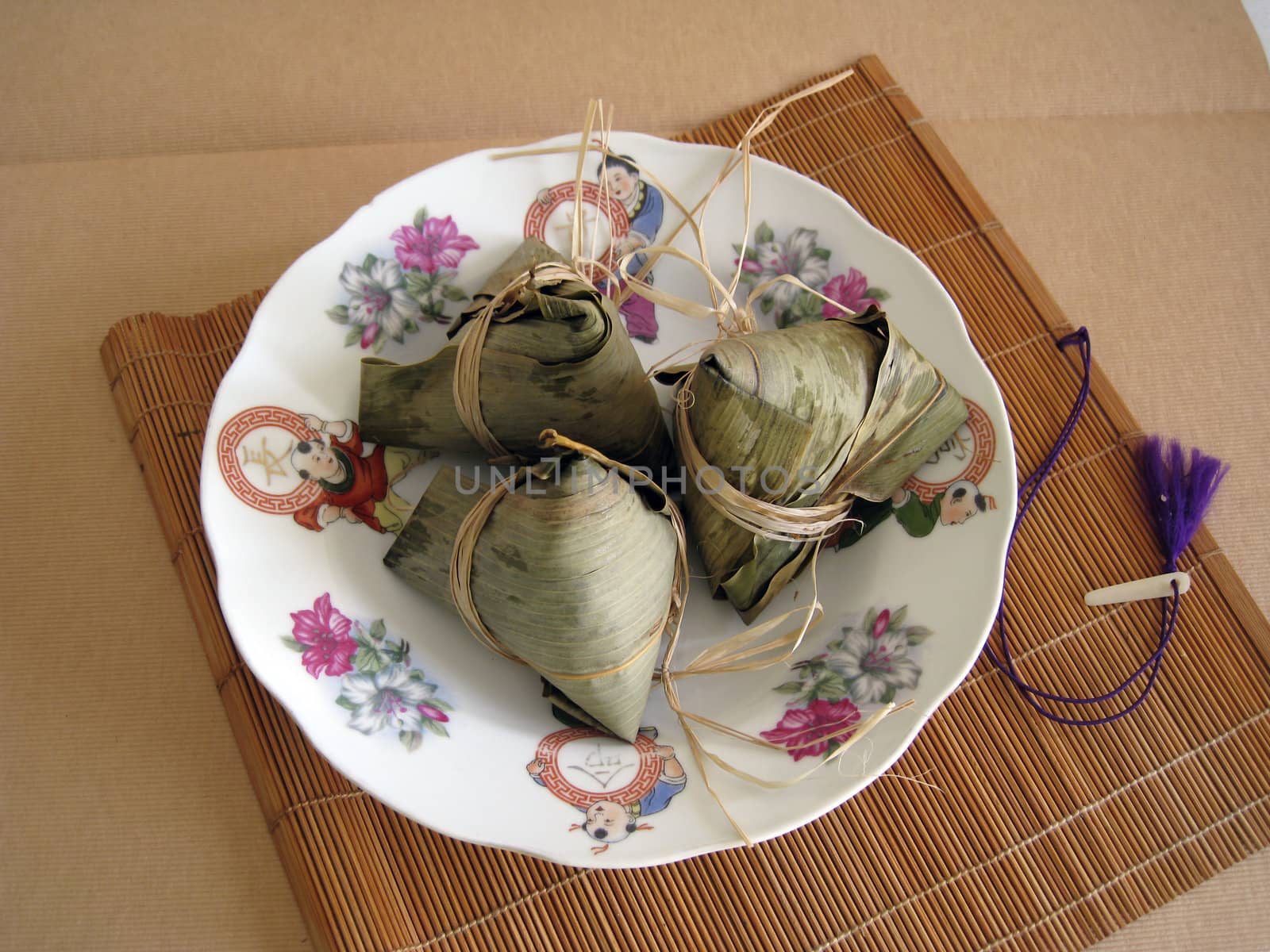 a pyramid-shaped mass of glutinous rice wrapped in leaves, one culture occasion in Chinese