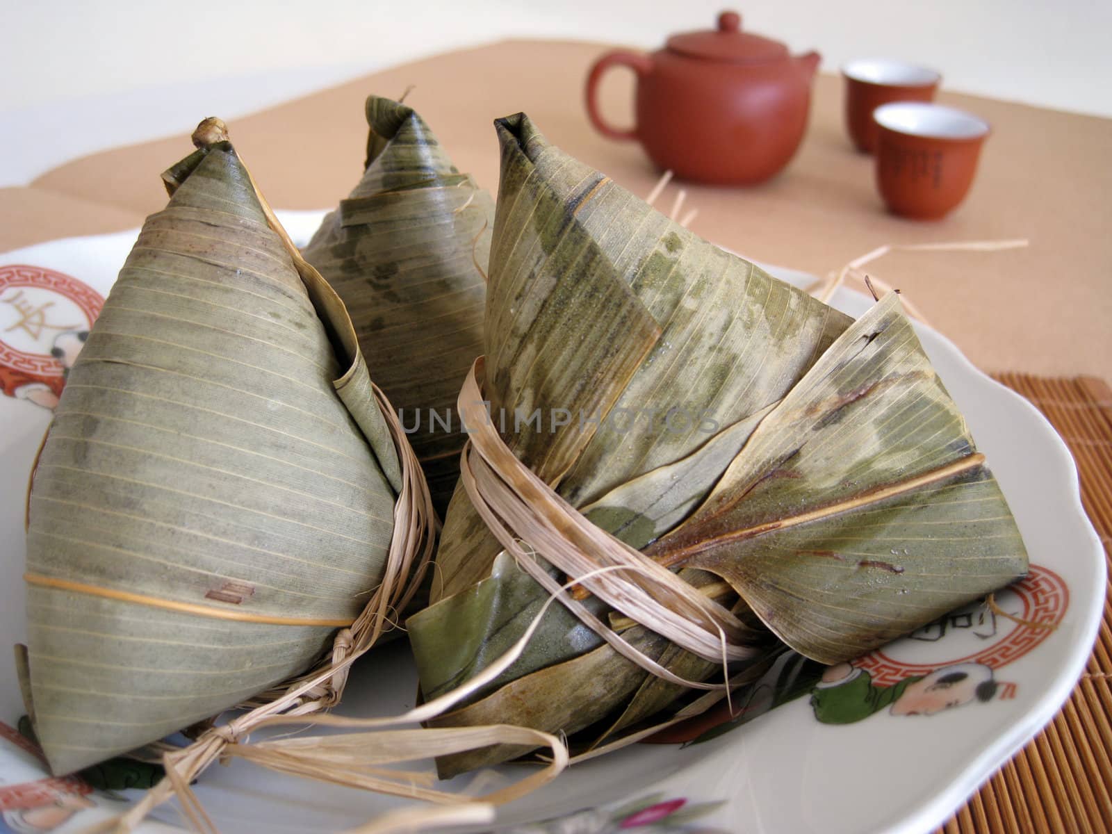 a pyramid-shaped mass of glutinous rice wrapped in leaves, one culture occasion in Chinese