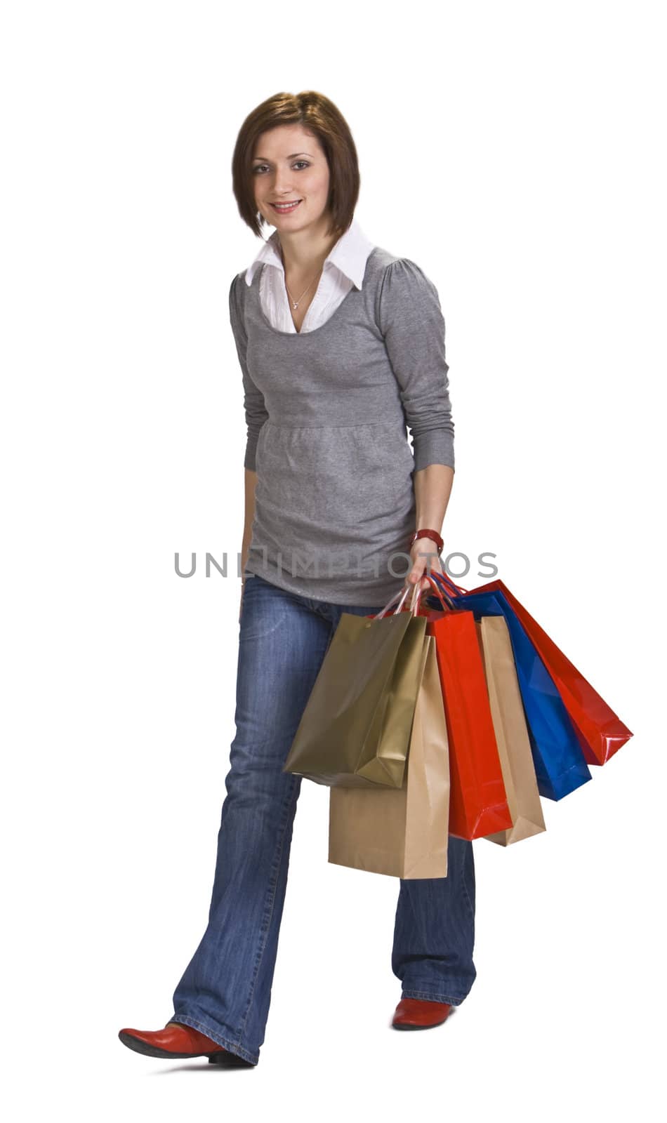 Woman with shopping bags walking,isolated against a white background.