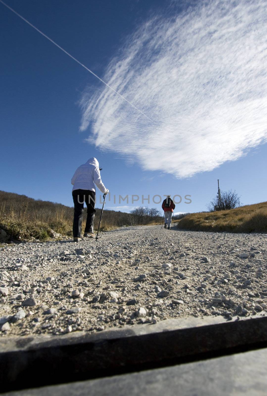 Couple hiking towards a transmitter antenna, Nanos - Slovenija.