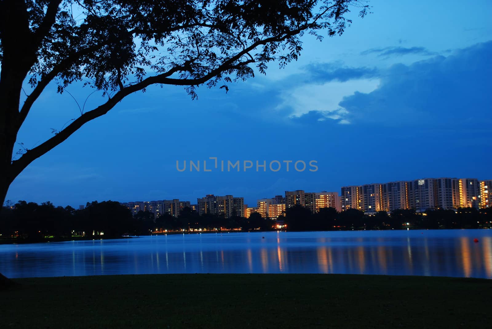 Housing estate building beautifully refelcted in a river in an evening at Singapore