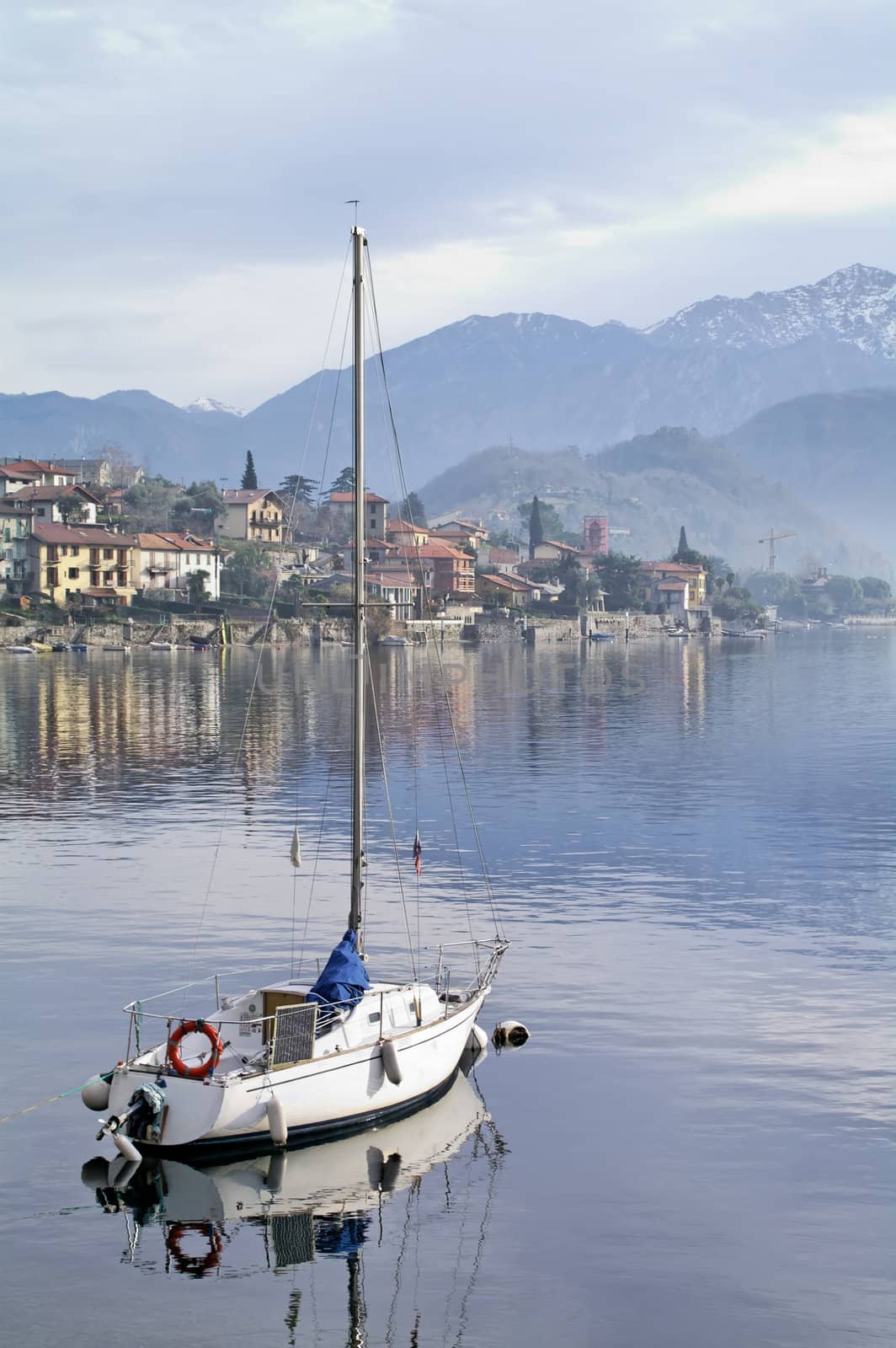 Moored sailboat in cloudy and misty day (vertical) - Como Italy