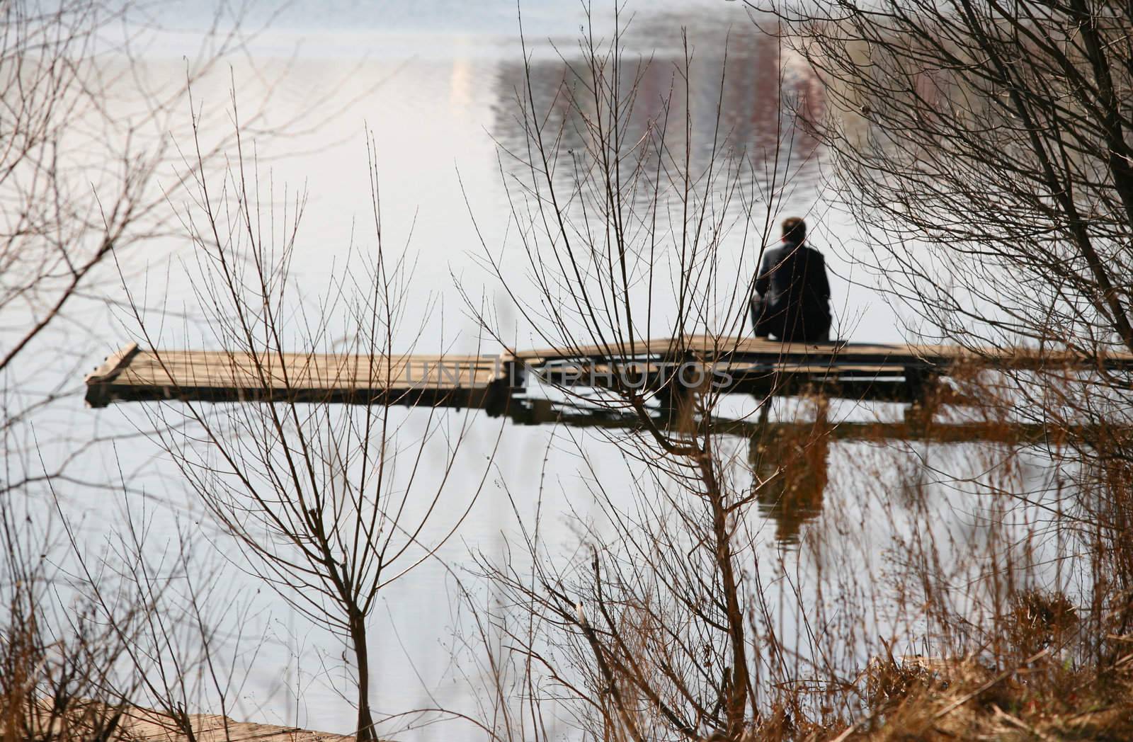 The image lonely man sitting on the bridge