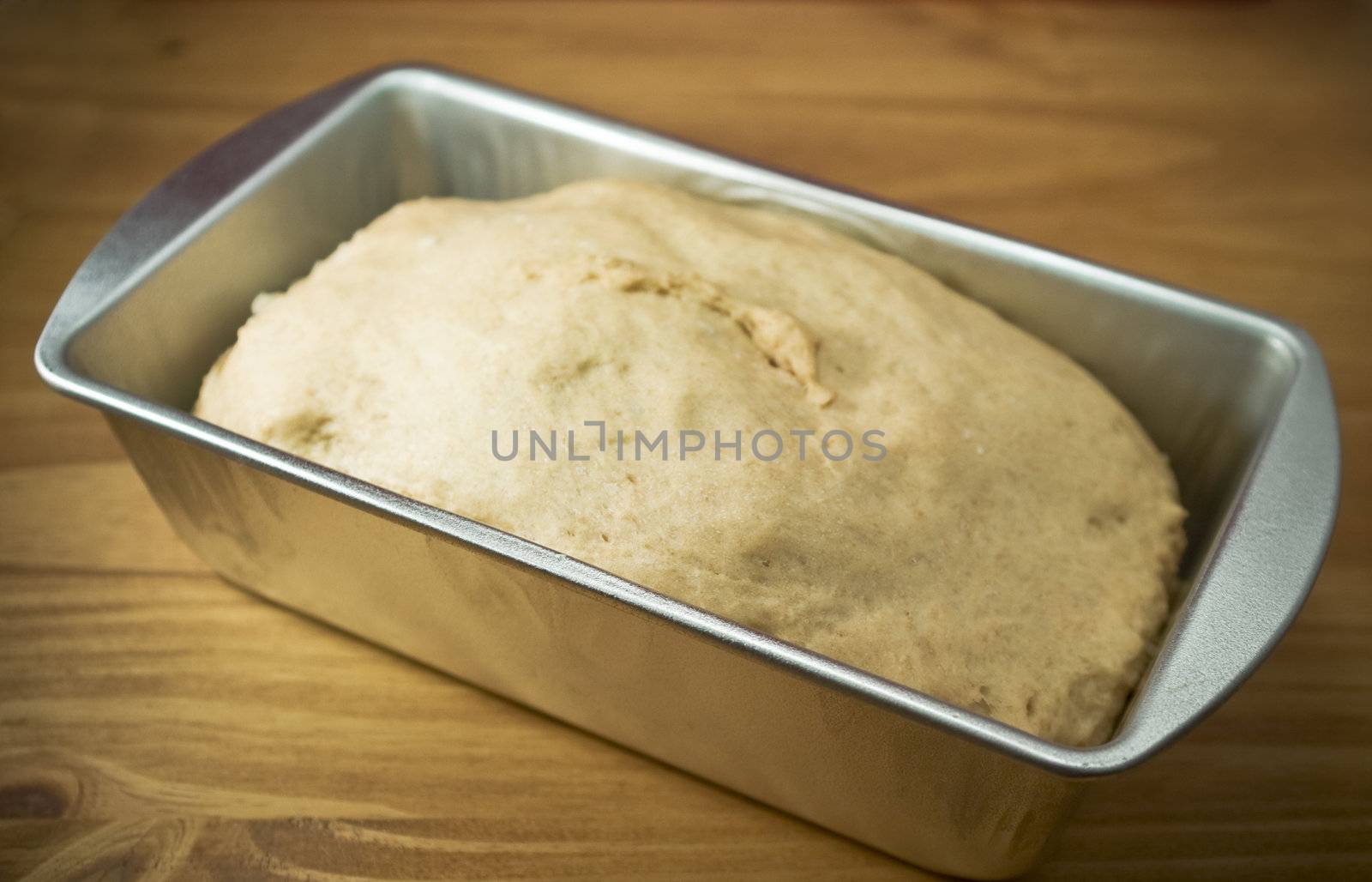 Fresh whole wheat dough in a baking pan

