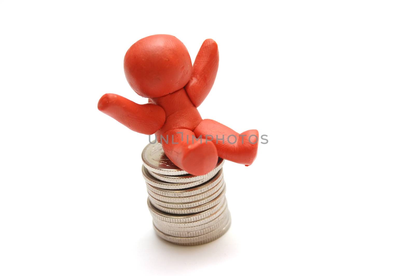 Plasticine figure sitting on coins pile. Winner in business