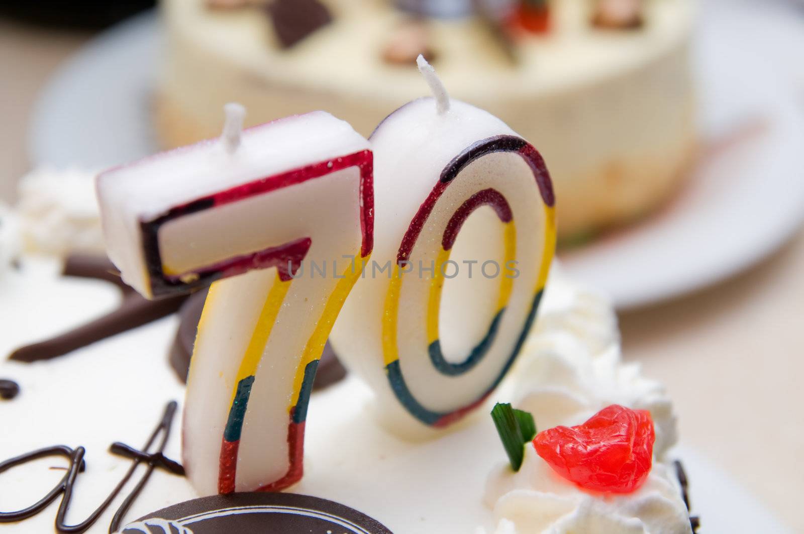 70 years old candles on a cream cake