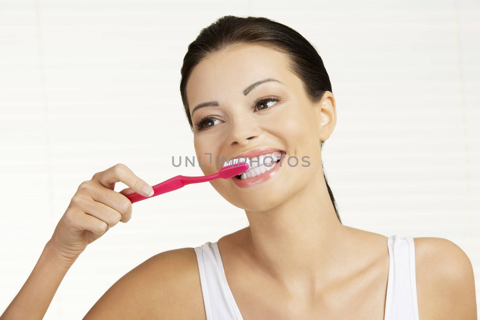 Woman holding tooth brush by BDS