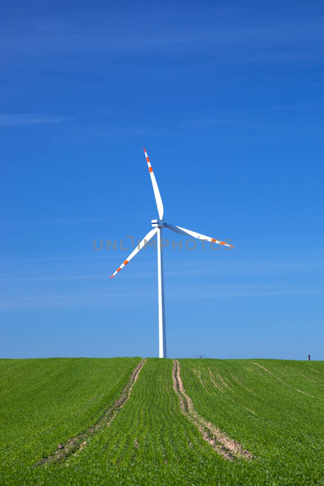 Wind Turbine on green field. Alternative energy, environment concept