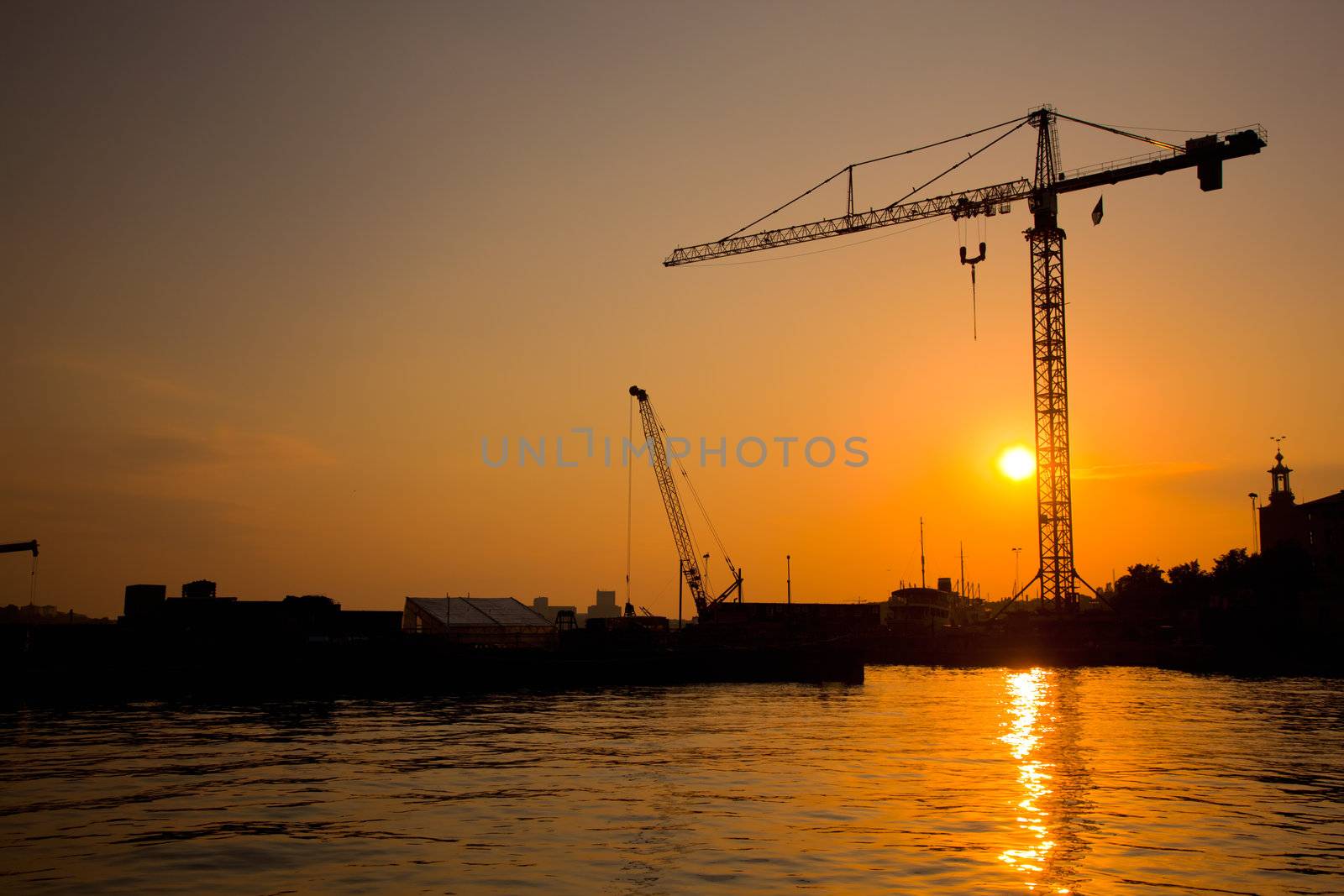 Industrial harbor, port at sunset and a crane