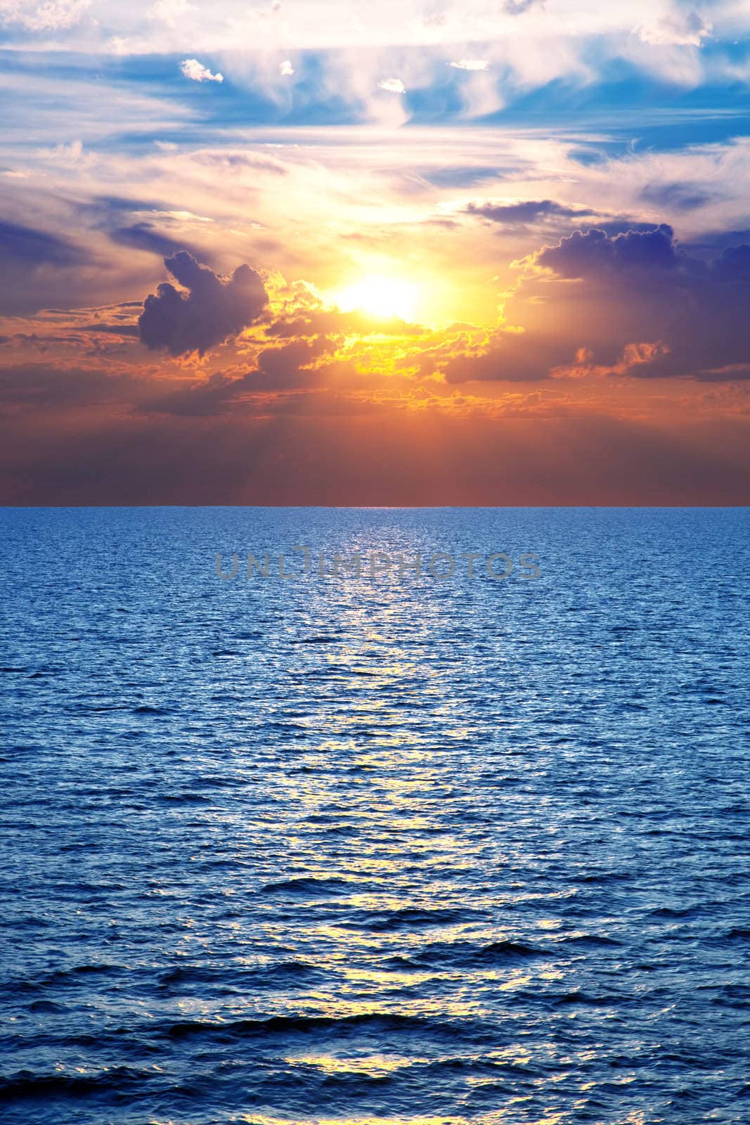 Sea, ocean at colorful sunset, vertical